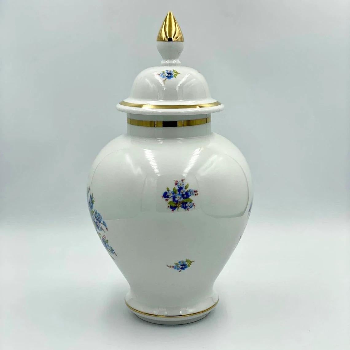 Schumann Arzberg, Germany, porcelain wild flowers gold trim.

Very nice Schumann porcelain white vase or urn with some gold wear. This features a bouquet of blue wild flowers with several smaller sprigs on the other sides. It has a rim with gold