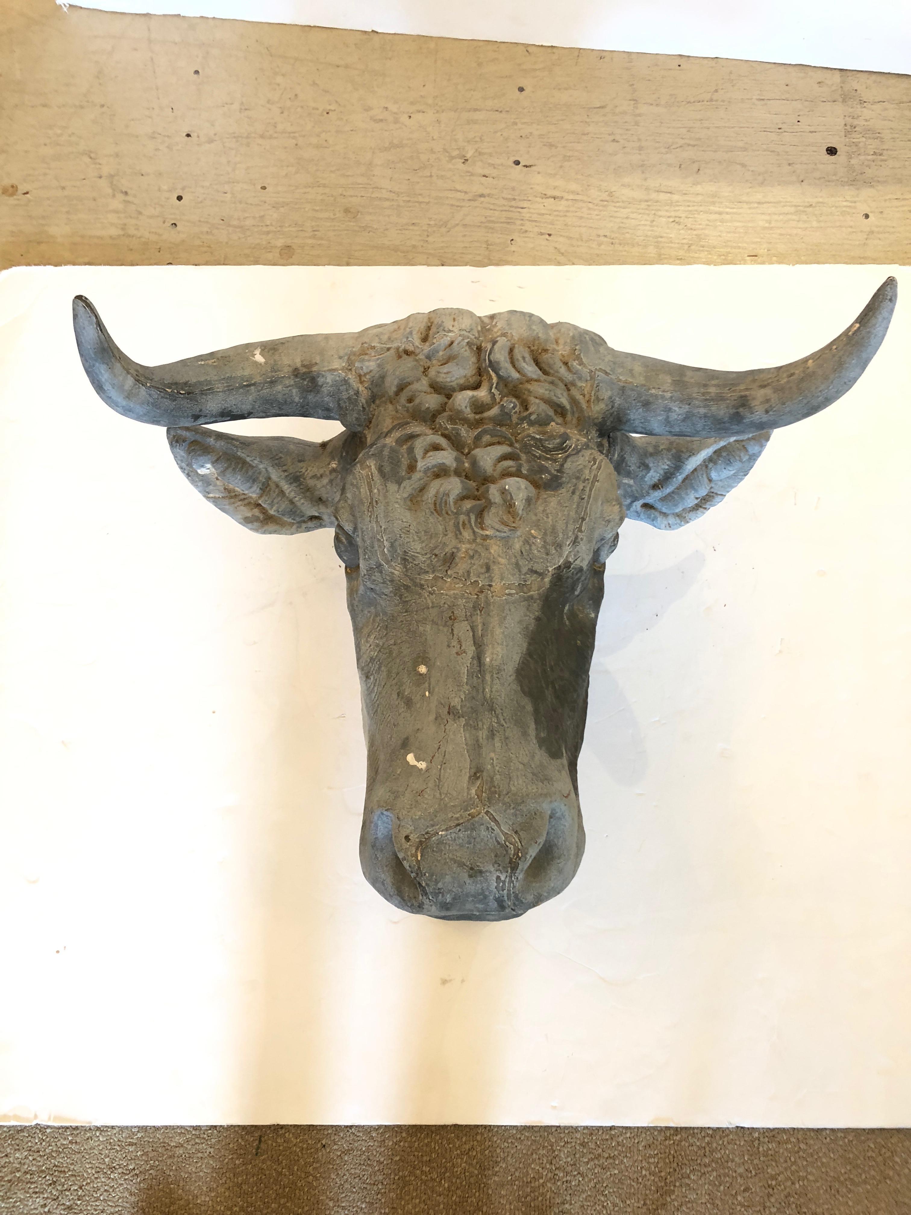 Rare tête de taureau ancienne en zinc provenant de France, vers 1860. Utilisée à l'origine comme enseigne commerciale pour une boucherie. Merveilleux état, patine de différentes nuances de gris, et une bande peinte rougeâtre en détresse autour du