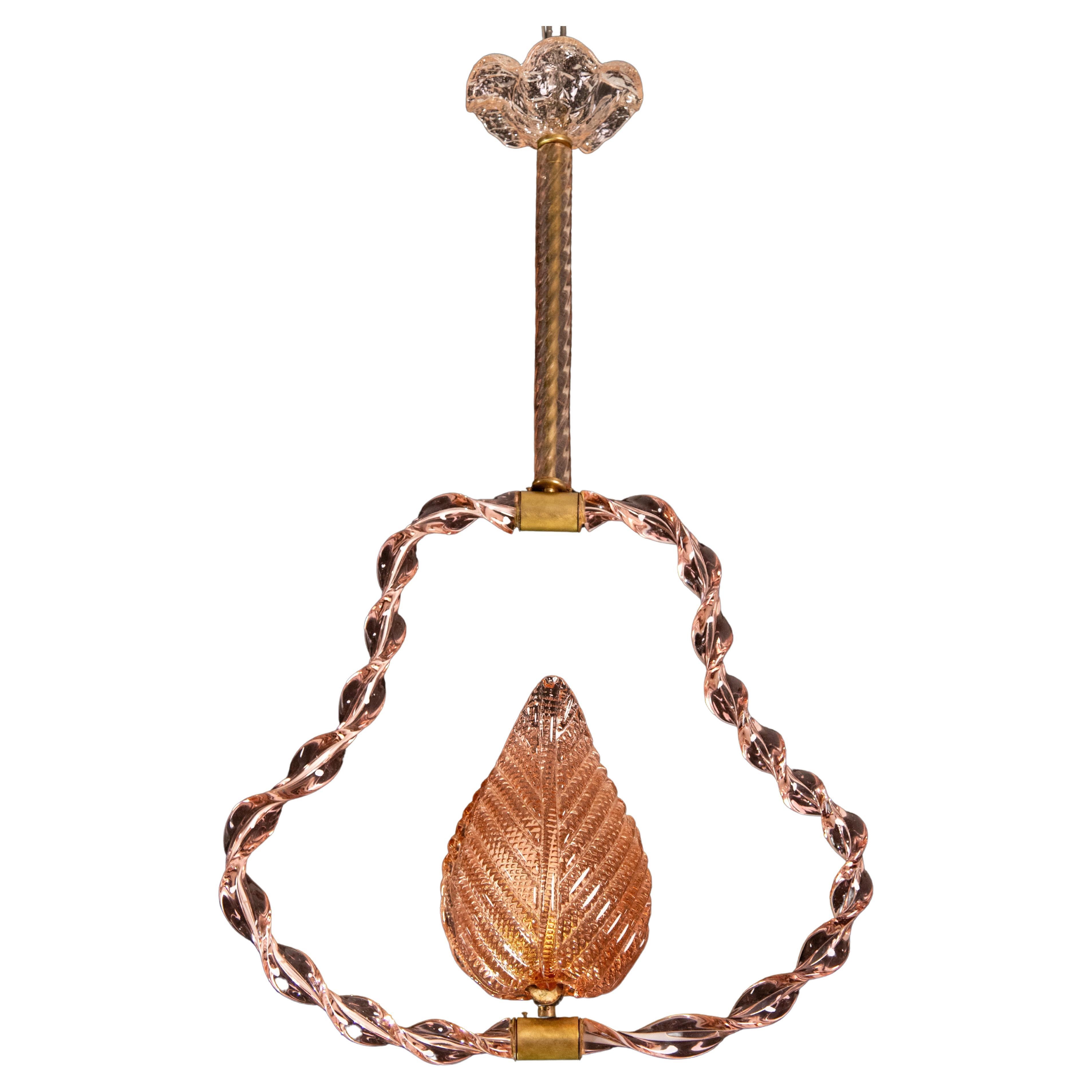 Stunning Murano chandelier by artist Ercole Barovier with rare Twisted pink glass.
The pendant consists of 6 glass elements and a brass structure.
It mounts a European standard e27 lamp.
It measures 80 centimetres in height and 50 centimetres in