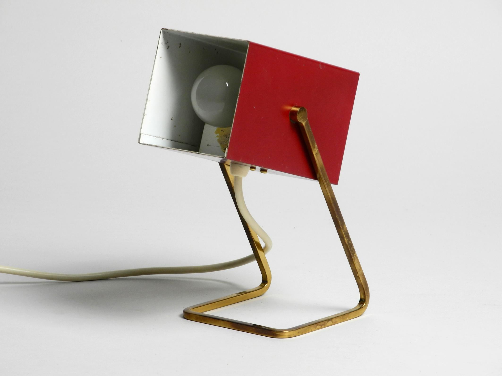 Stunning Kaiser Mid-Century Modern metal bedside lamp.
Painted red outside and white inside. Very rare to find with angular shade,
which is steplessly movable.
Very high quality, entirely made of metal.
Good vintage condition without damages to