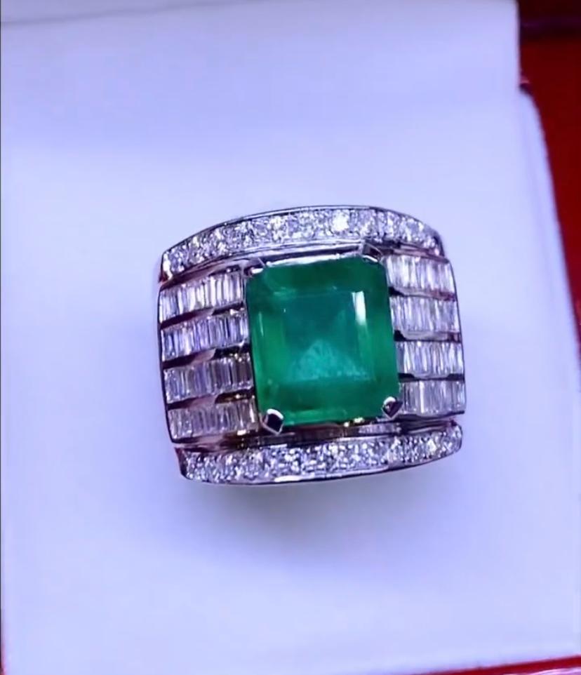 A fabulous piece of contemporary art, for this exclusive ring, so stunning and refined , from Italian designer, in 18k gold with a natural Zambia emerald in emerald cut of 4,45 carats, fine quality, and natural baguettes and round brilliant cut