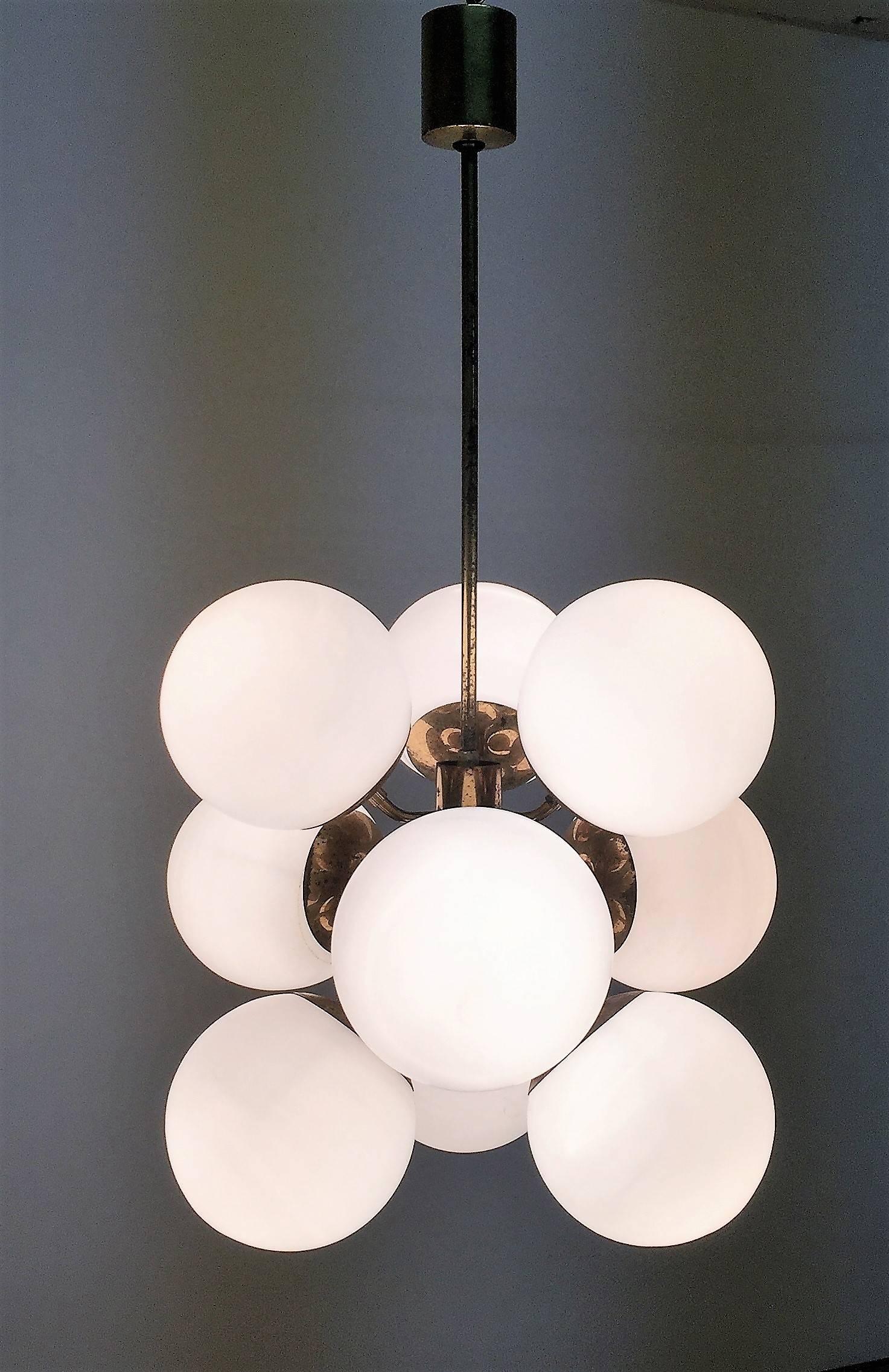 Amazing set of Mid-Century Modern Sputnik chandeliers with nine white glass globes and patinated metal frame.
Socket: Nine e27 for standard screw bulbs
This amazing set of eight, nine-light Sputnik chandeliers comes from a big dinning room.
Good