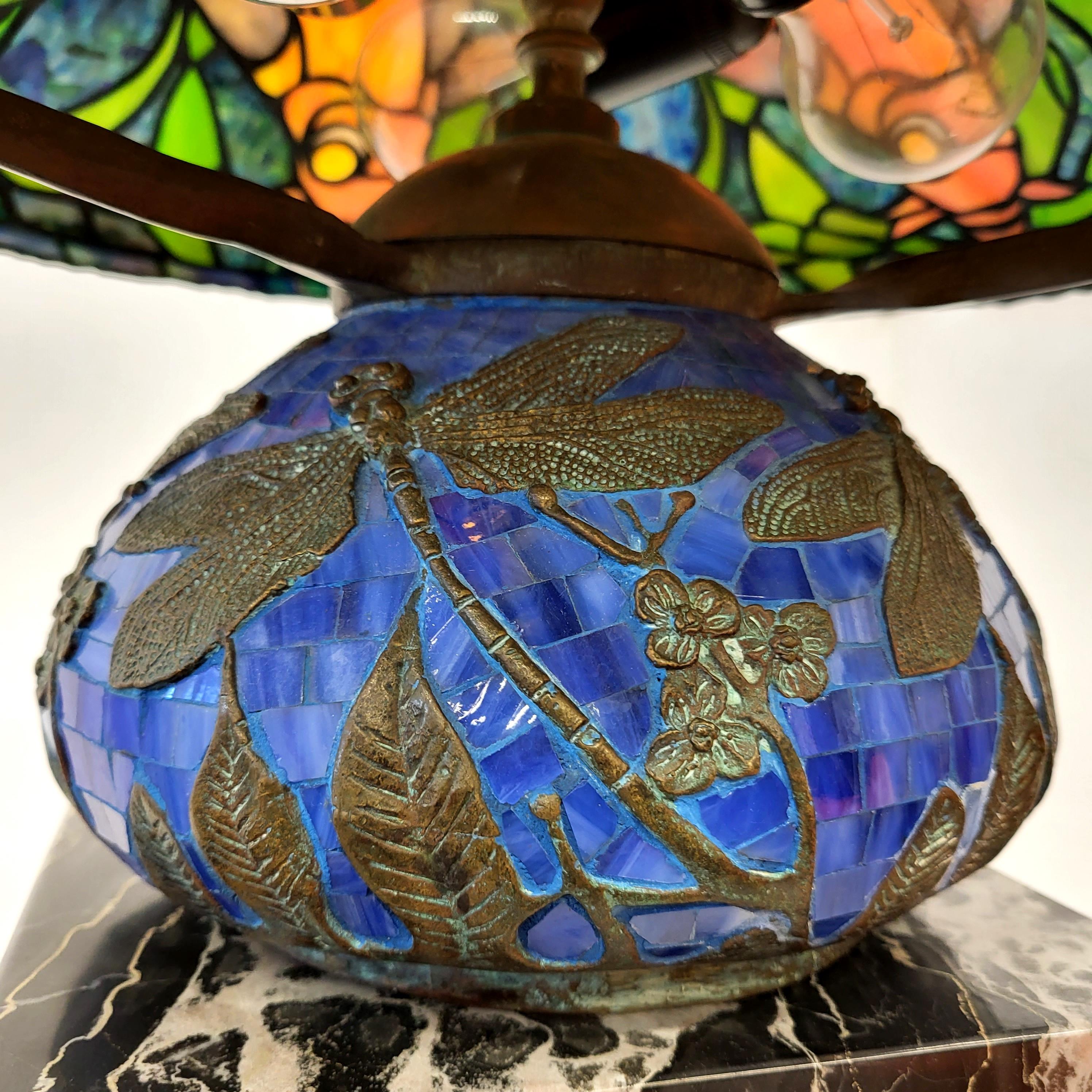Stunning and amazing table lamp in the manner of Tiffany Studios. 
Very impressive handmade lamp with a wonderful blue libelle base.
 
Very fine handwork, colourful glass. In the manner of the Dragonfly lamp.

The lamp has an amazing warm light and