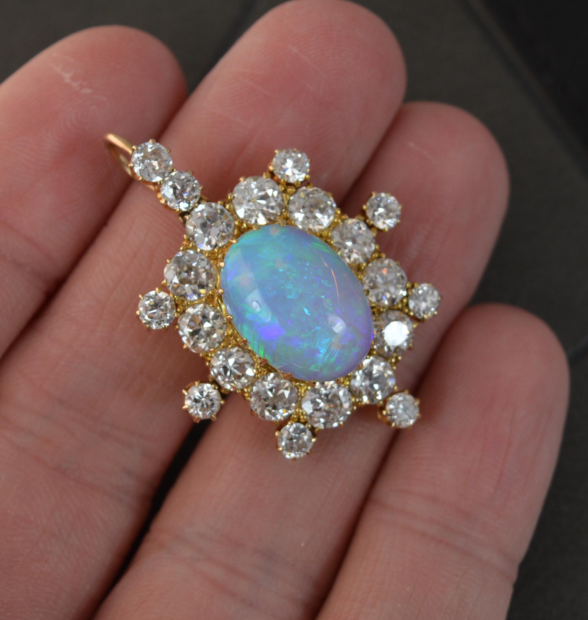 A stunning Victorian period pendant, circa 1880.
Solid 18 carat yellow gold example.
Designed with an oval shaped opal to centre, 10mm x 15mm approx. Full of colour throughout.
Surrounding are twelve large old European cut diamonds with an