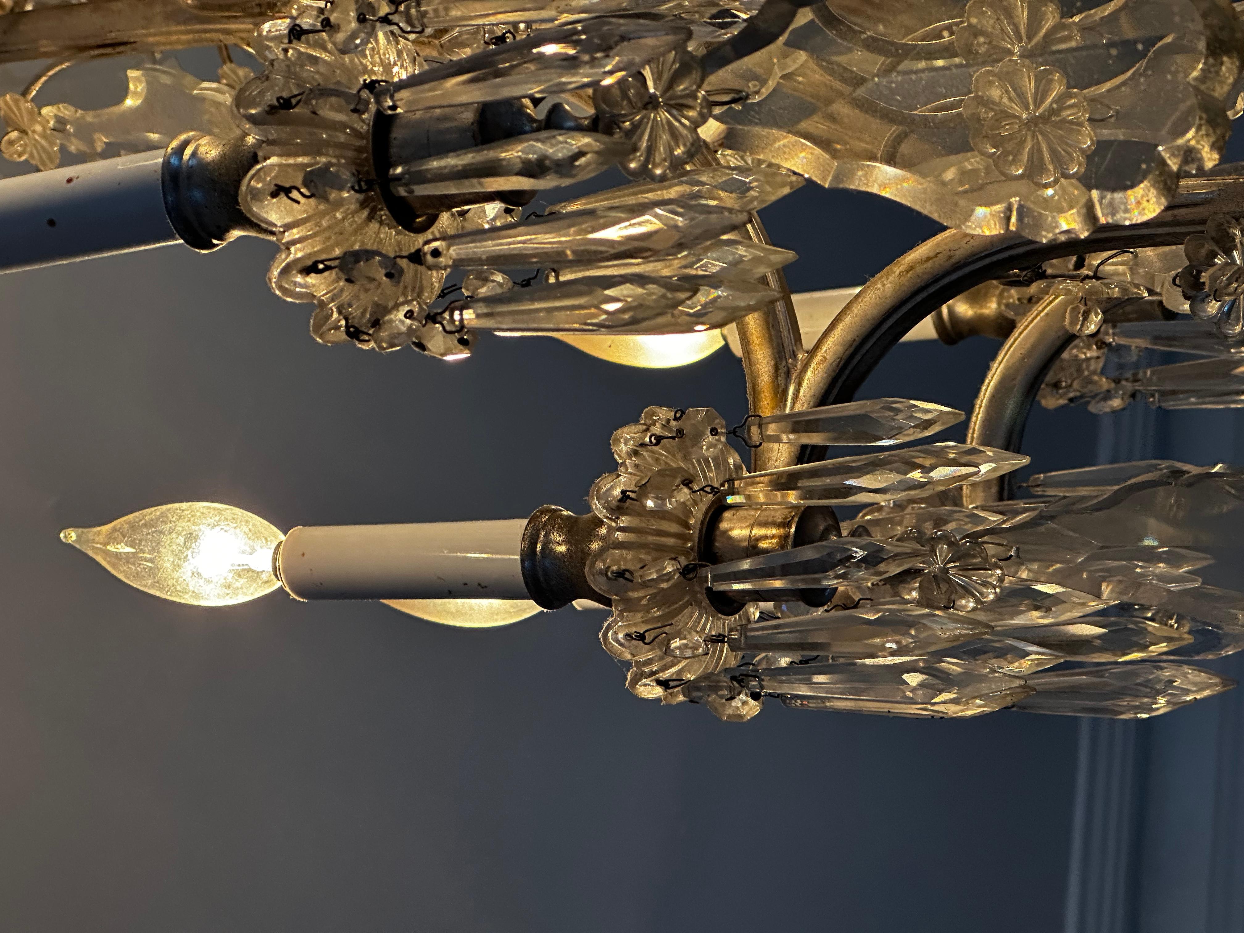 Pleased to offer this excellent 10 light crystal and silver plated vintage chandelier. It comes fresh from a Brooklyn, NY brownstone. It has four additional interior lights to enhance the overall beauty of the piece. It has been recently rewired and