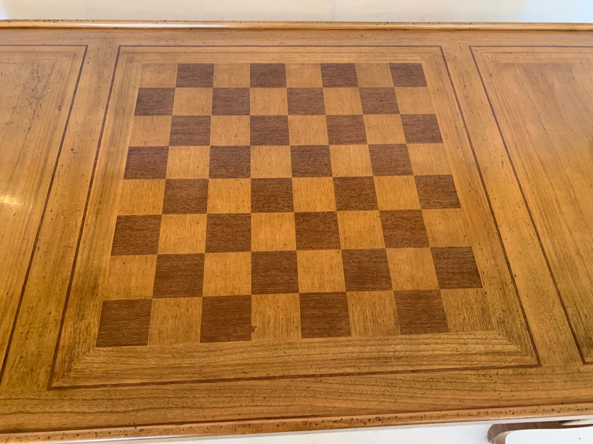 A versatile and beautiful French vintage mahogany and fruitwood inlay game table having
backgammon, checkers, chess, and one side felted card table. Handsome from every angle as table is 
finished all around and has two drawers on each side. One
