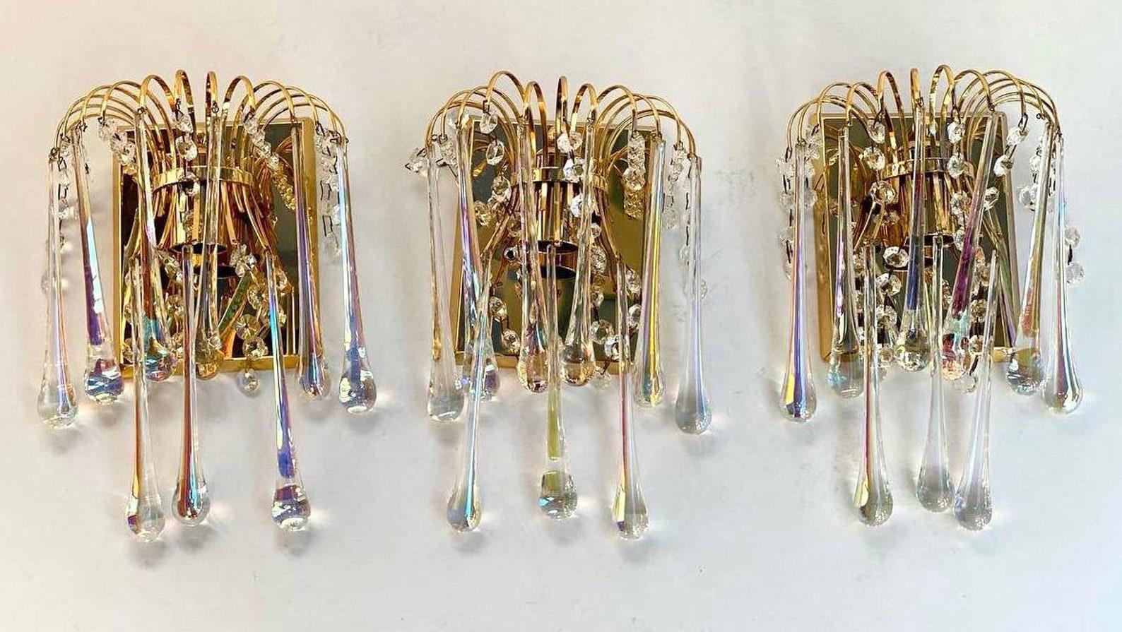 A wonderful and rare set of three gilt brass and crystal cascading waterfall wall sconces. 

 Vintage handblown crystal teardrops wall sconces. 

 The naturalness of the compositions is added by pendants made in the form of balls on long glass