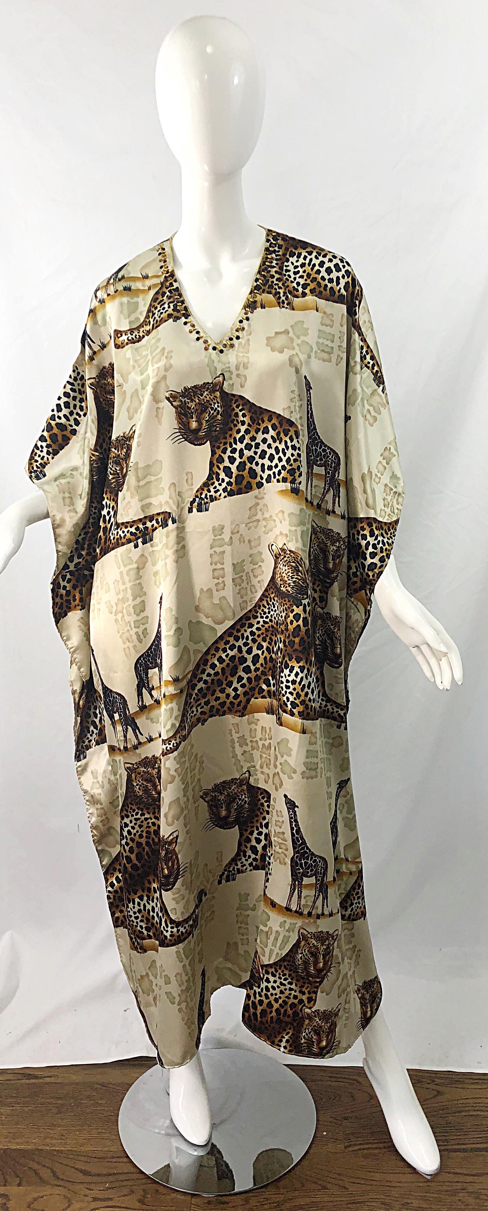 Channel your inner Joe Exotic or Carol Baskin in this amazing vintage animal print kaftan maxi dress ! Sequins and beads sewn around the collar. Features leopards, giraffes, etc printed throughout. Warm tones of brown, tan, ivory, rust, and black.