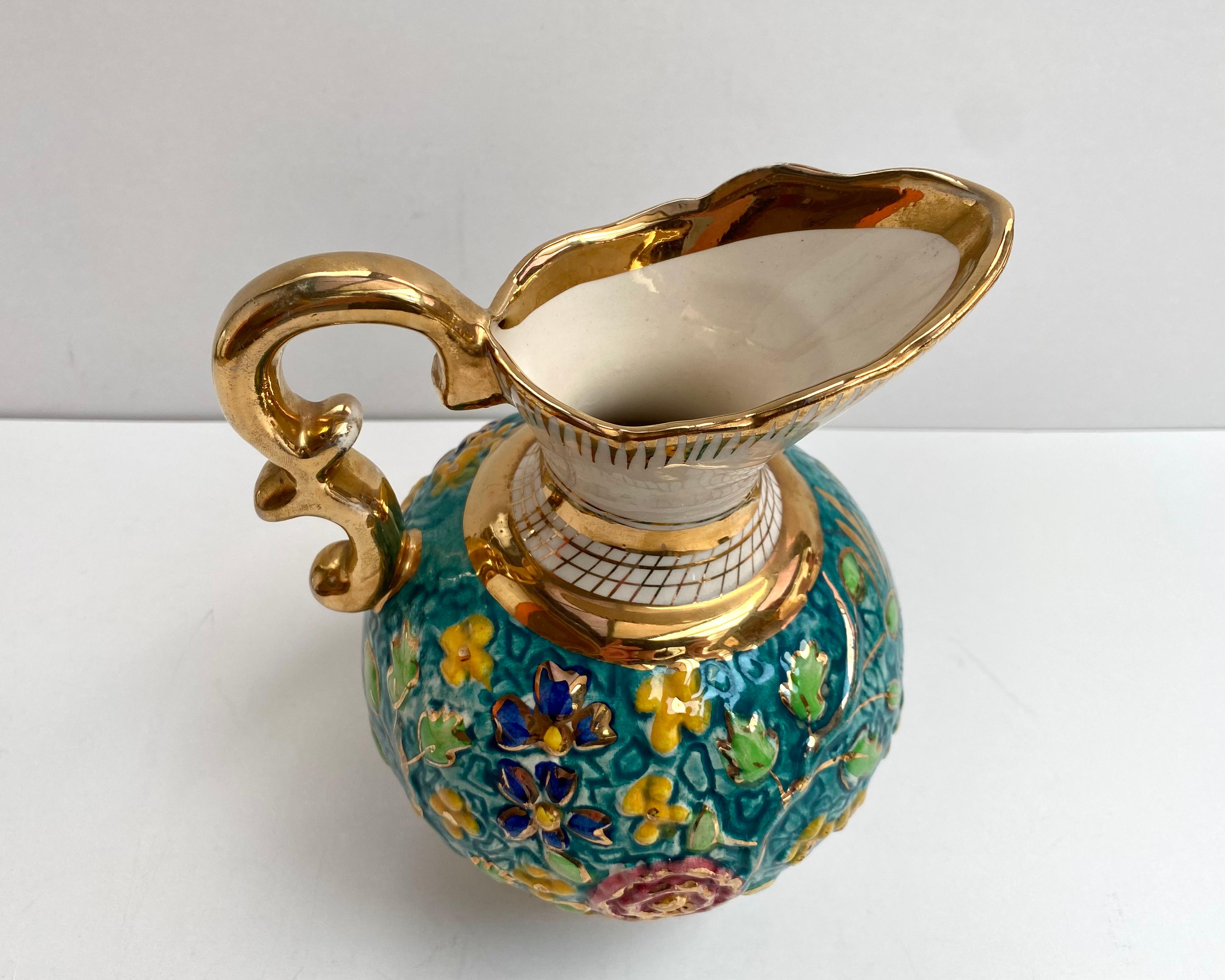 Vintage, hand painted ewer.

Gorgeous faience pitcher vase with a beautifull turquoise background decorated with a bright raised enamel and 24K gold pattern of a colorful flowers.

Belgium. 1950s.

All hand crafted and hand painted. All accents in