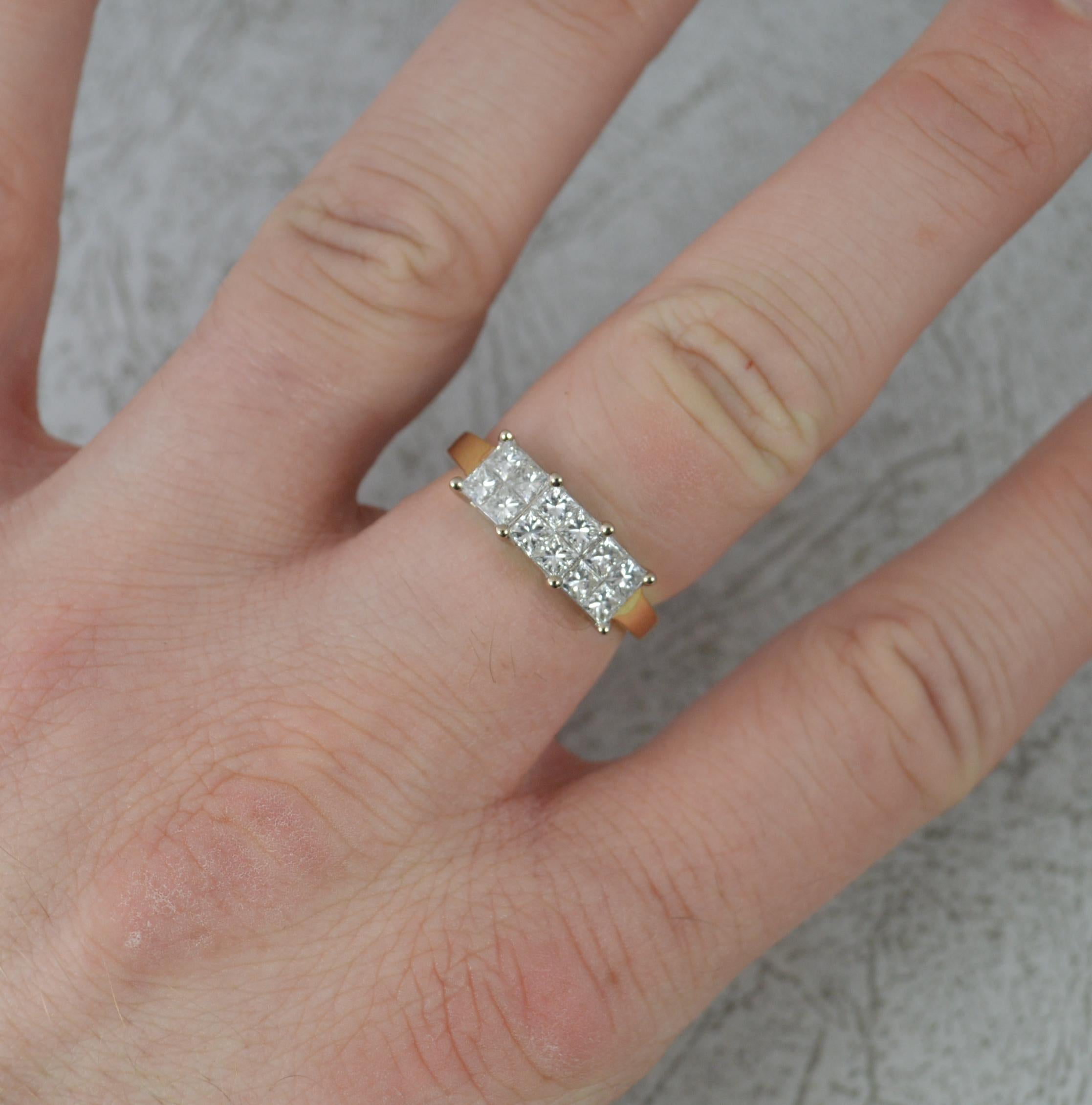 A well made diamond cluster ring.
Solid 18 carat yellow gold shank and white gold head setting.
Designed with three triple clusters of four princess cut diamonds. 1.00 carat total weight. Vs clarity, g-h colour.
15mm x 6mm cluster head.

CONDITION ;
