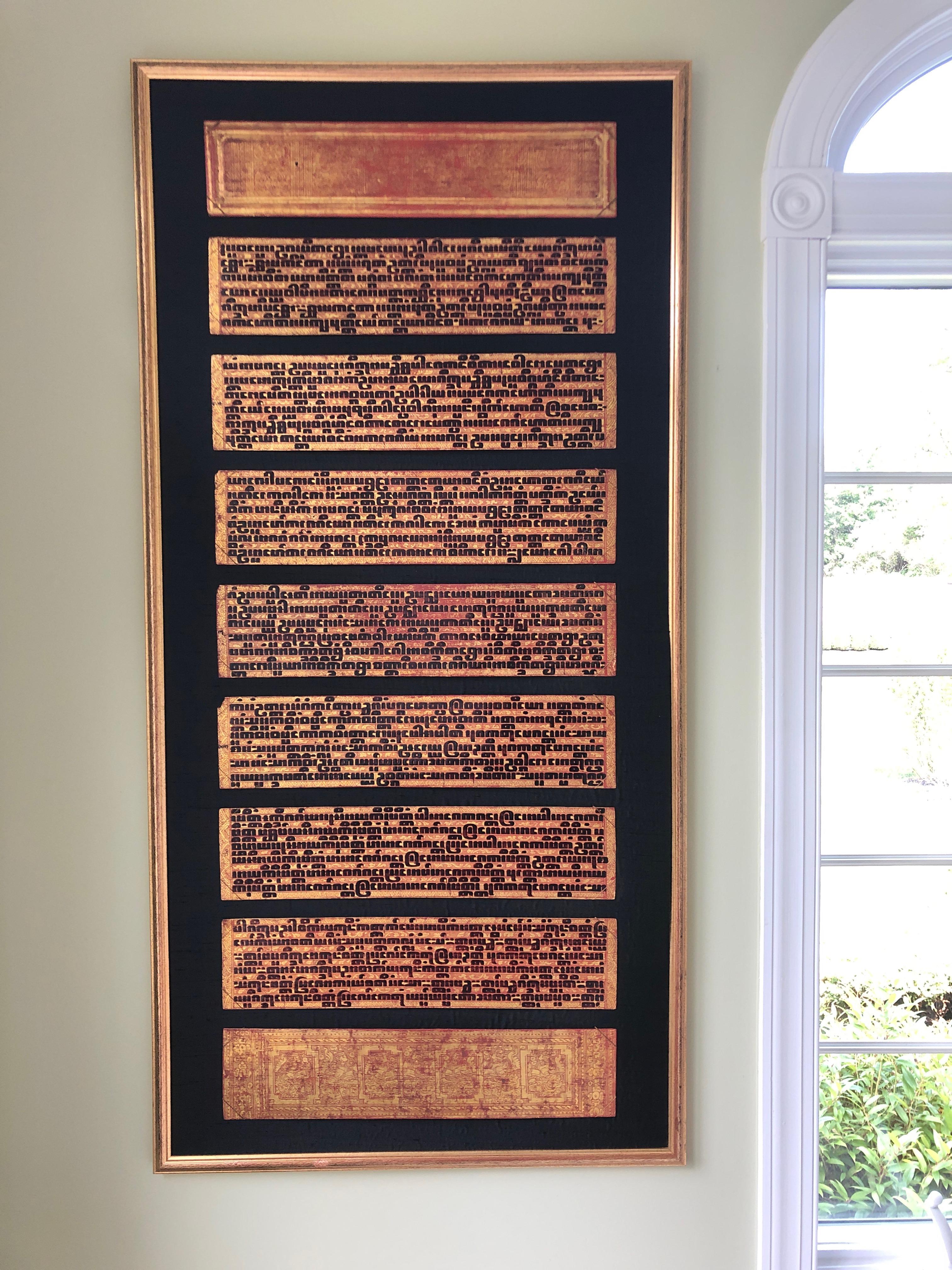 Stunning pair of large framed art that displays the intricate laquer panels from an antique Burmese bible called the Kamawa-sa, a religious text from the Pali Vinaya. Palm leaf and paper manuscripts of Myanmar, this is by far the most ornate