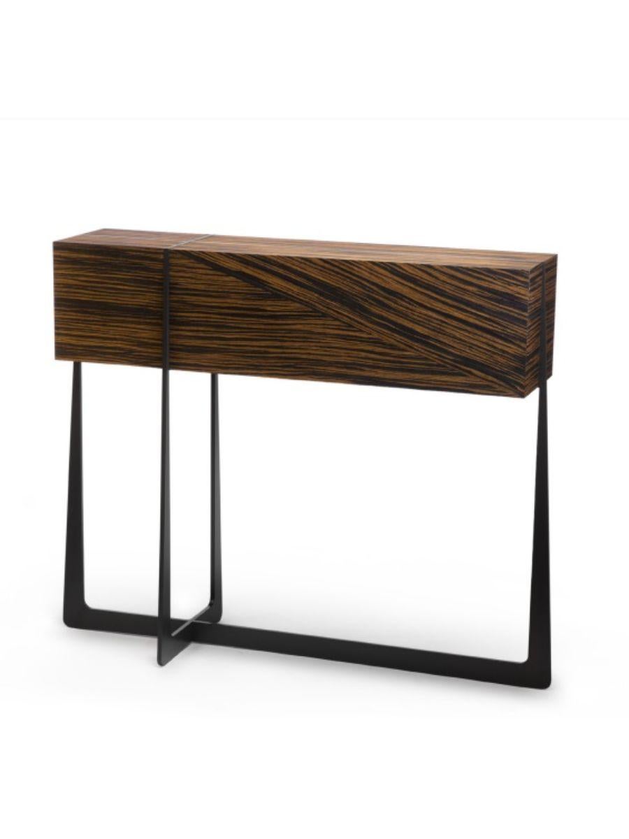 Amazone console by Plumbum 
Dimensions: L 100/110 x D 25 x H 87 cm 
Materials: Steel and ebena wood reconstituted veneer. 

Influenced by French Decorative Arts, Amazone is a small console that combines strength and femininity.
The very light curves