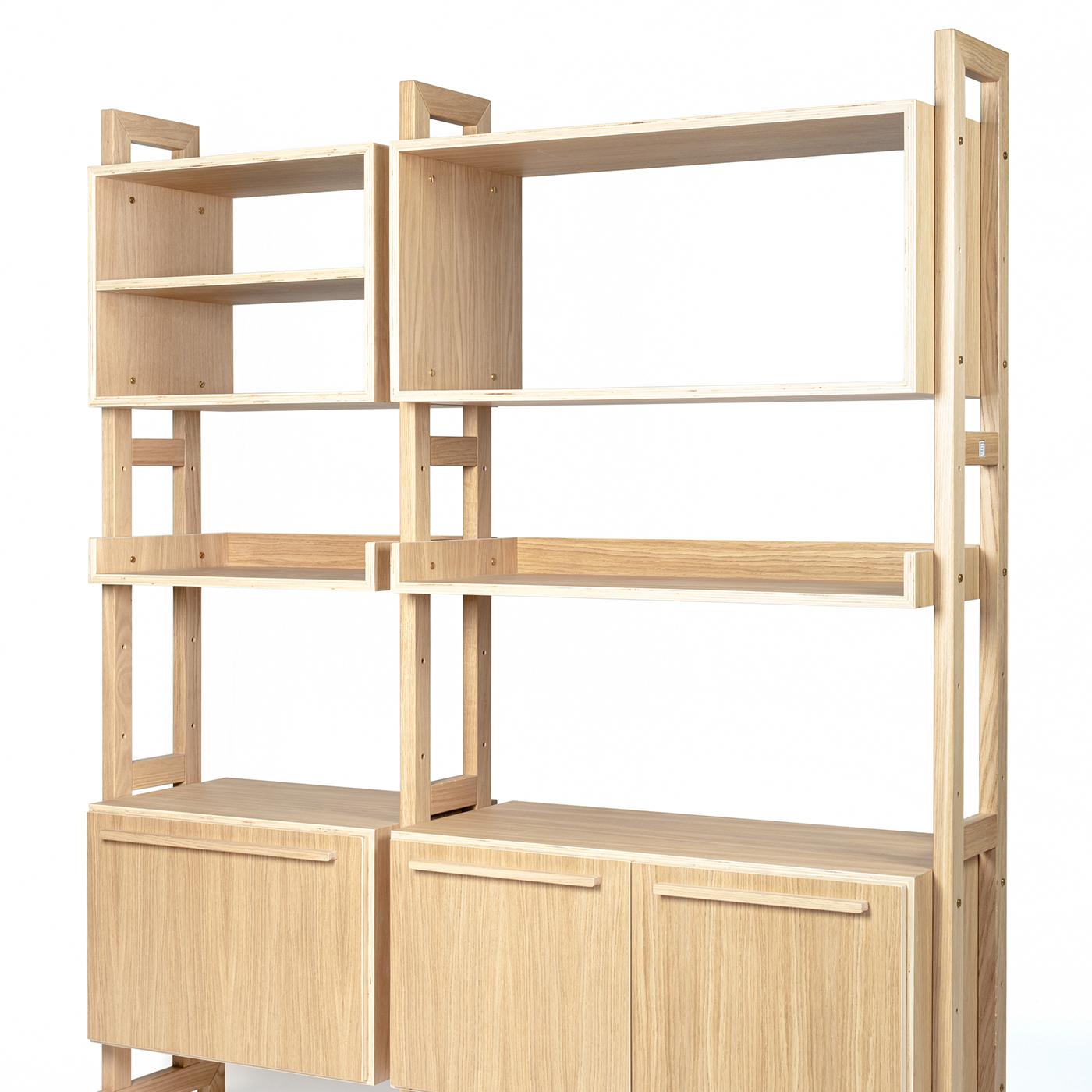 Give any living or office space a modern touch with this customizable, modular bookshelf with supporting sides in solid oak and oak plywood shelves and containers. The entire piece is covered in a natural, water-based paint finish for a clean and