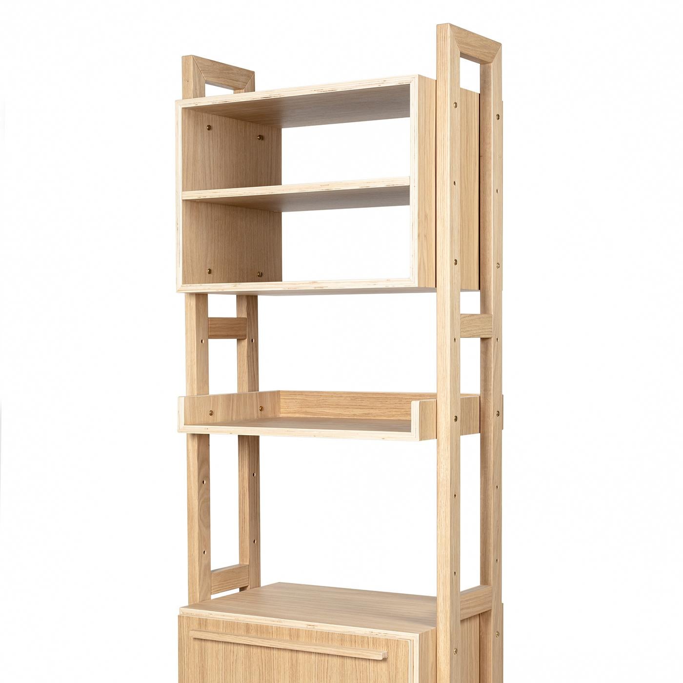 This modern, modular bookshelf has supporting sides in solid oak while its containers and shelves are in oak plywood. This piece is finished in a natural water-based paint and has holes drilled at different heights in the supporting sides to ensure