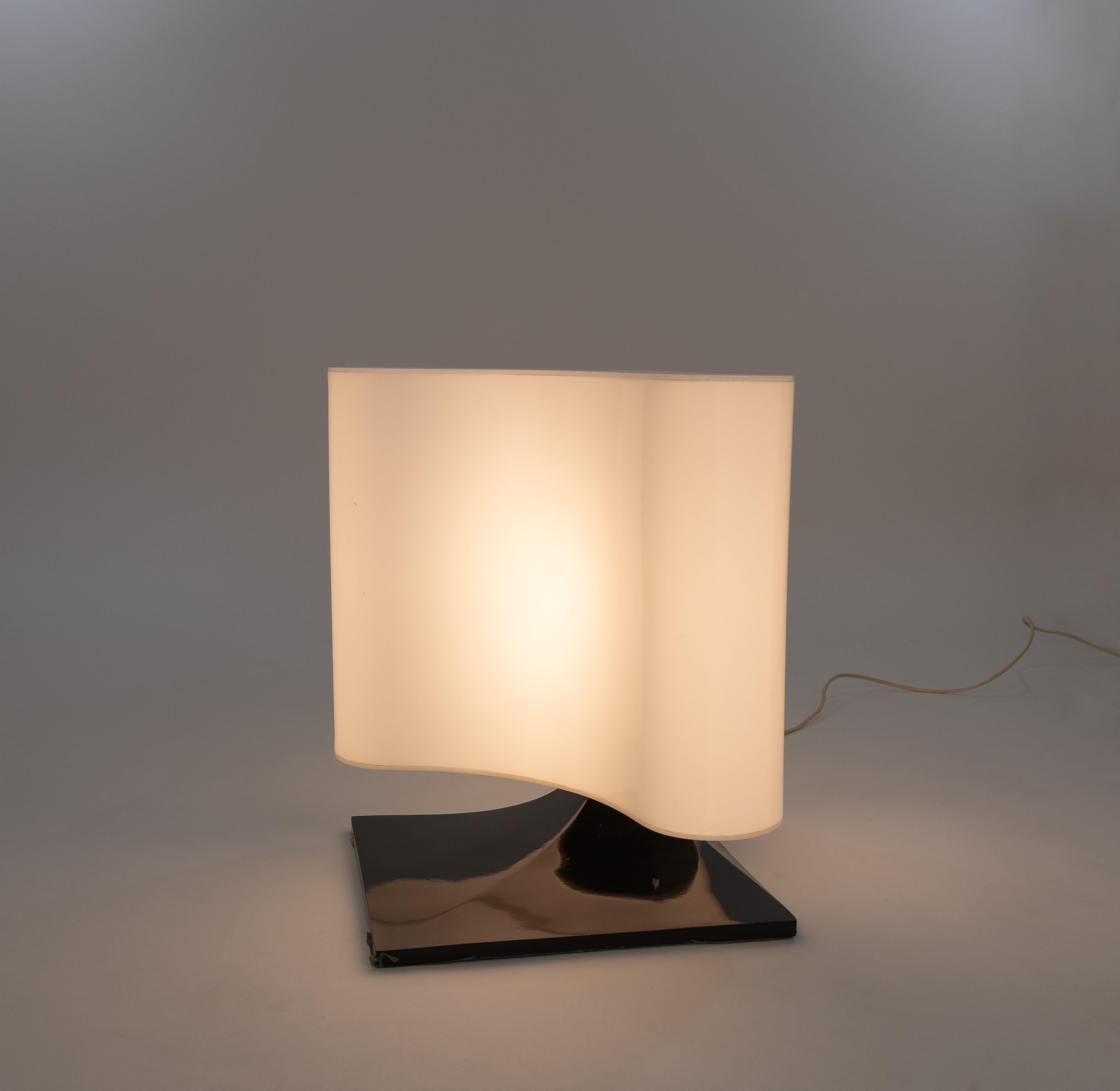 Ambasciata table lamp designed by Vittorio Introini in the late 1960s and manufactured by Stilnovo.

The lamp consists of a white plastic shade that is positioned on a curved black metal base. Introini also designed an Ambasciata pendant which