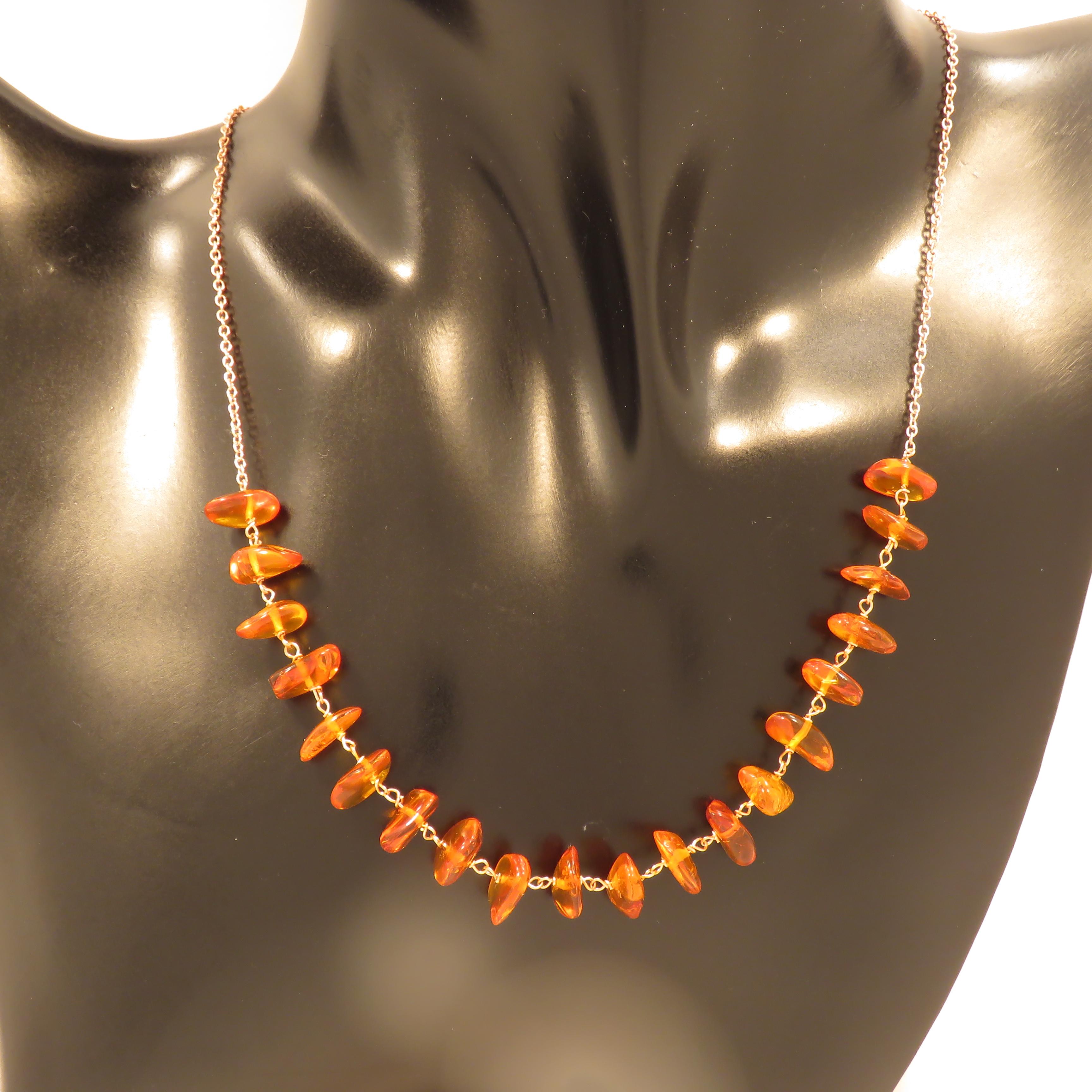 Beautiful necklace with genuine yellow honey amber and 9 karat rose gold rolo chain. The necklace length is adjustable from 410 mm to 445 mm / from 16.141 inches to 17.519 inches, it is possible to lengthen the necklace on customer's request.