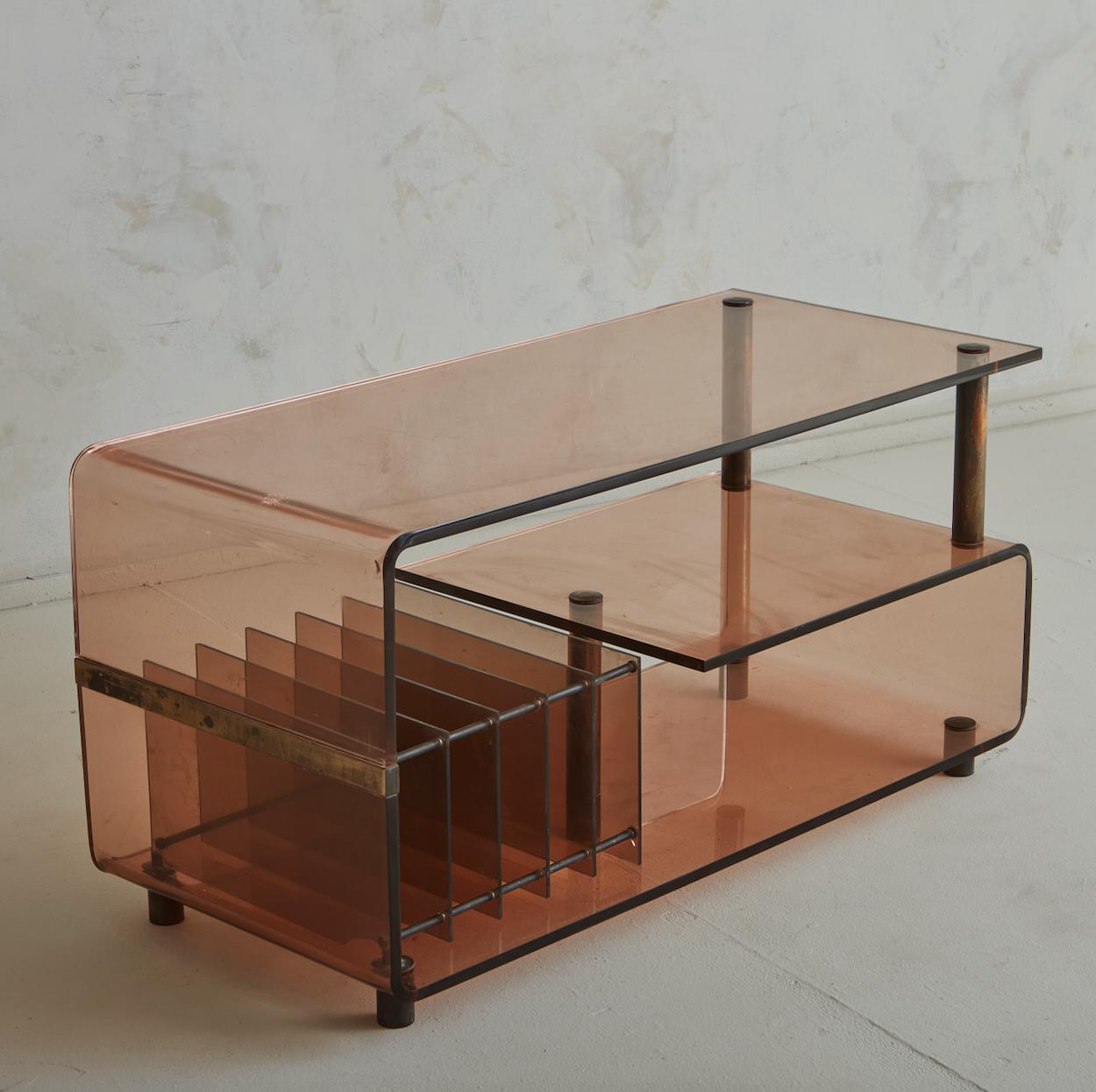 A 1970s French console table attributed to Michel Dumas. This Modernist table is constructed of smoked acrylic in a hybrid shade of amethyst and amber. The tiered silhouette, featuring a wide rectangular surface and central shelf that spans a