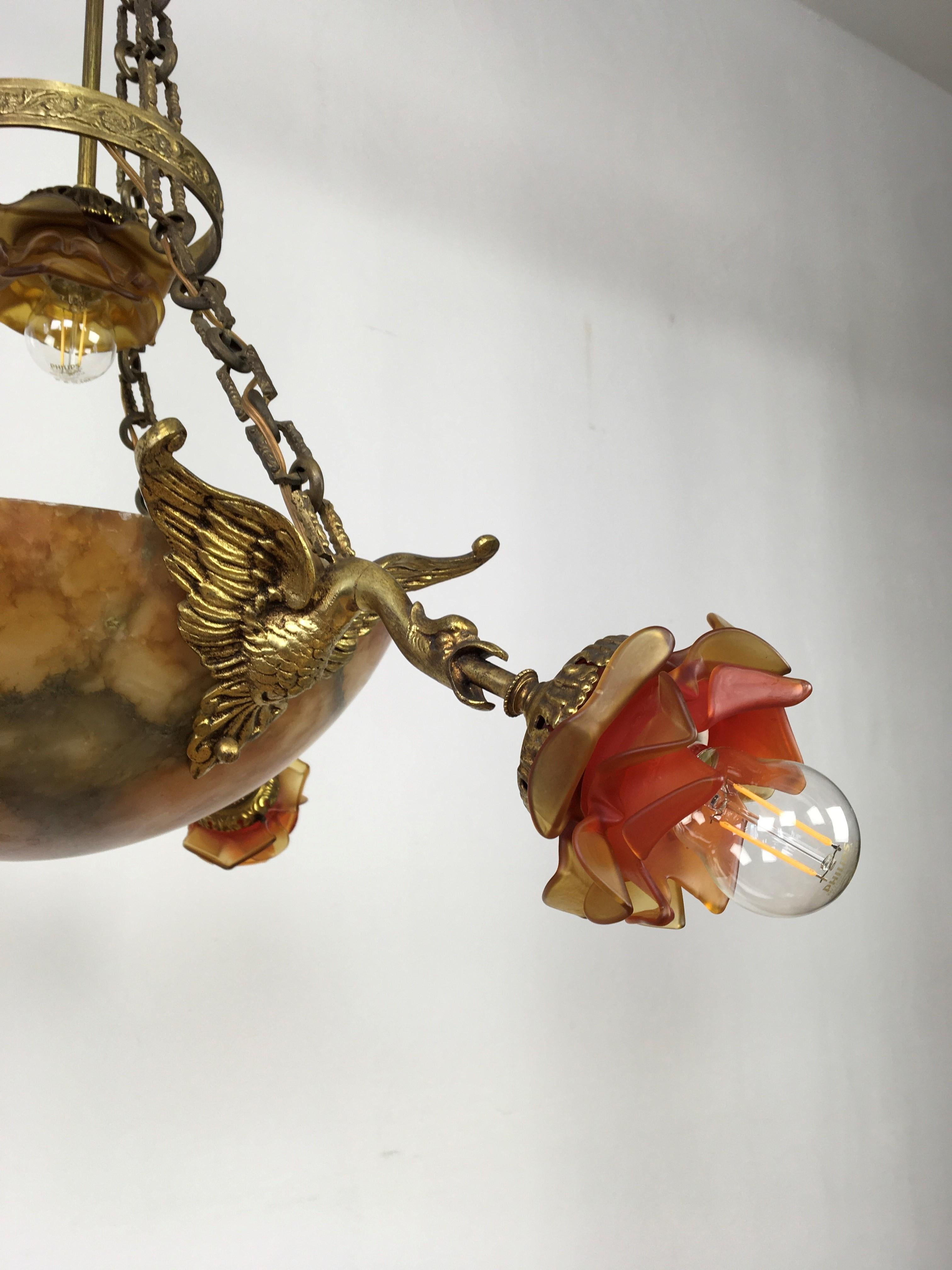 Antique alabaster bowl chandelier. 
A French Alabaster chandelier or pendant consisting a veined amber alabaster bowl, floral lampshades and dragons. 
An Art Deco ceiling light with graceful shades in the shape of roses which are held by a kind of