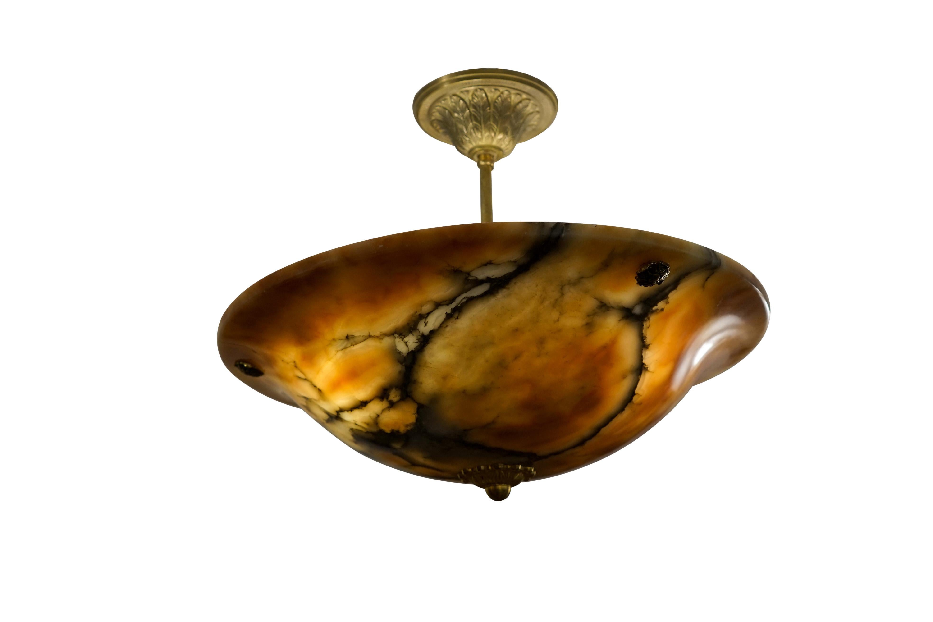 An elegant shape carved from a dramatic multi-hues amber alabaster provides depth of color at all levels of light.
