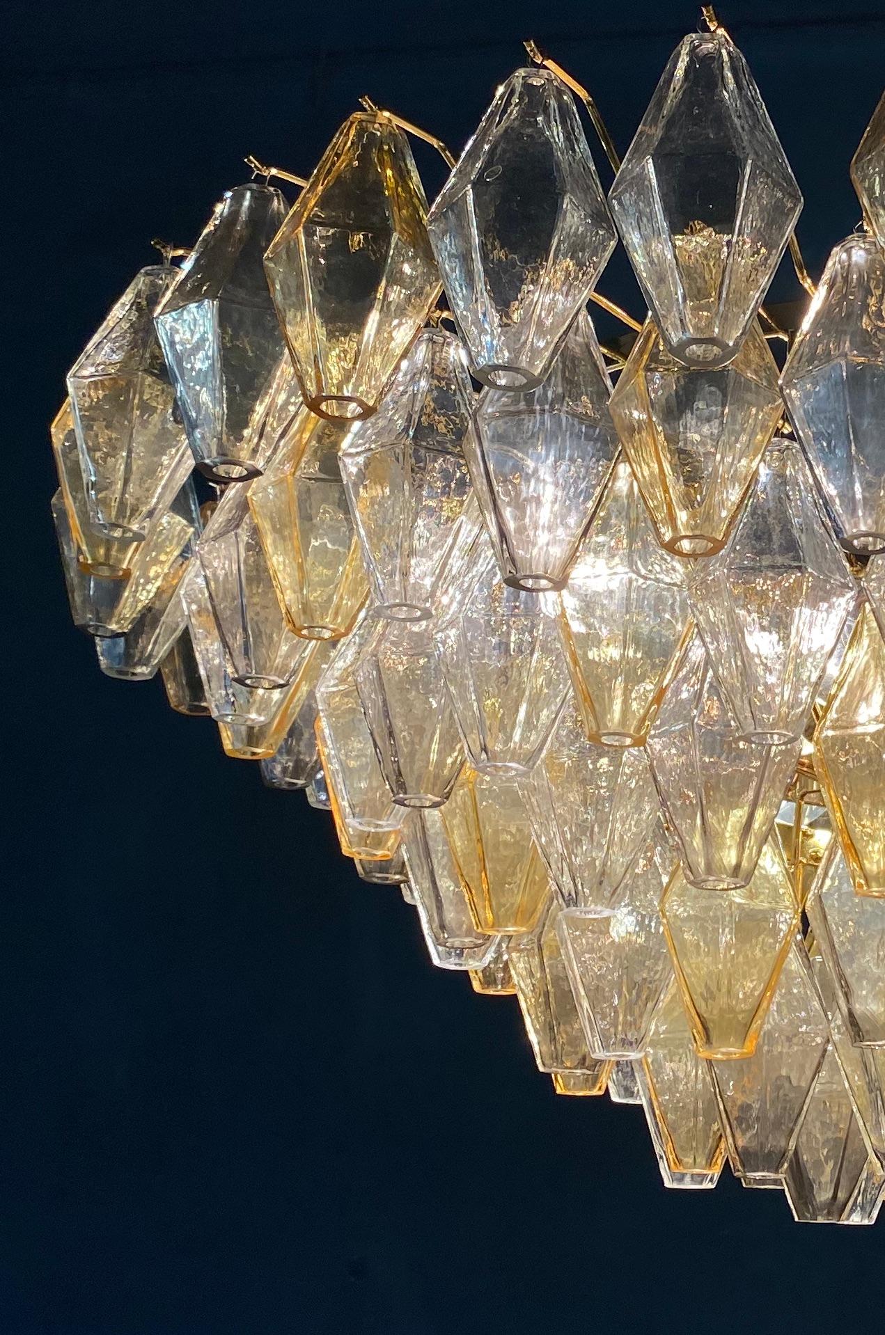 This chandelier consists dozens of hand blown gray, amber and clear 