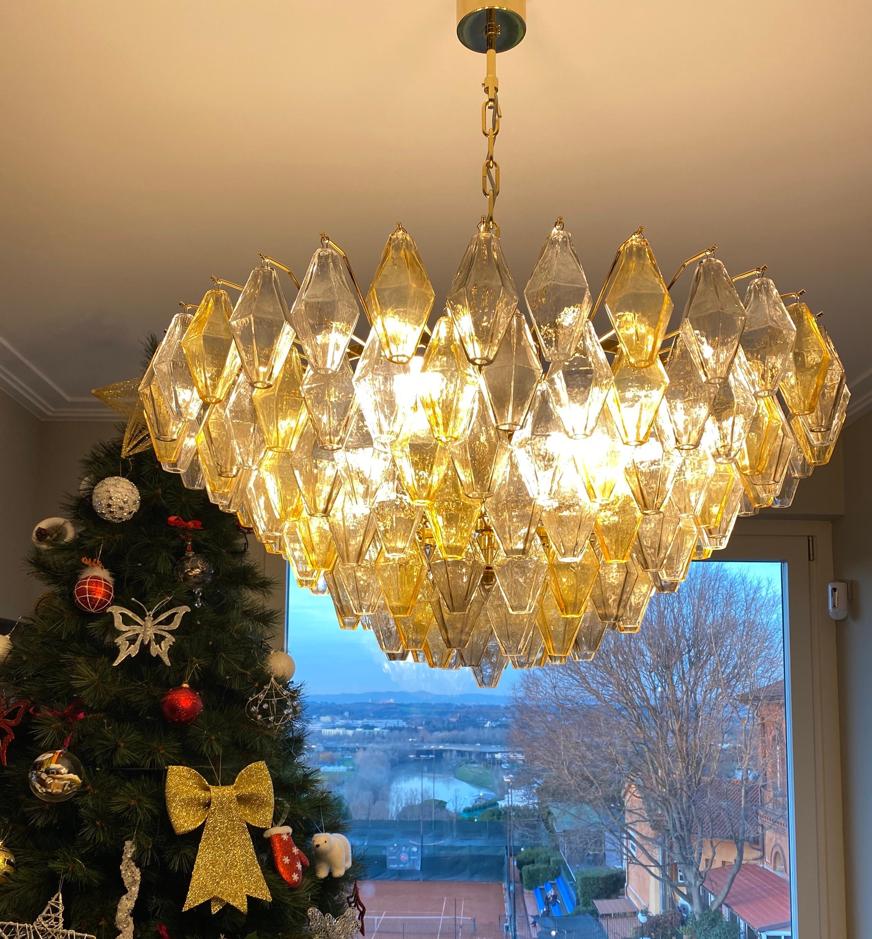 This chandelier consists dozens of hand blown gray, amber and clear 
