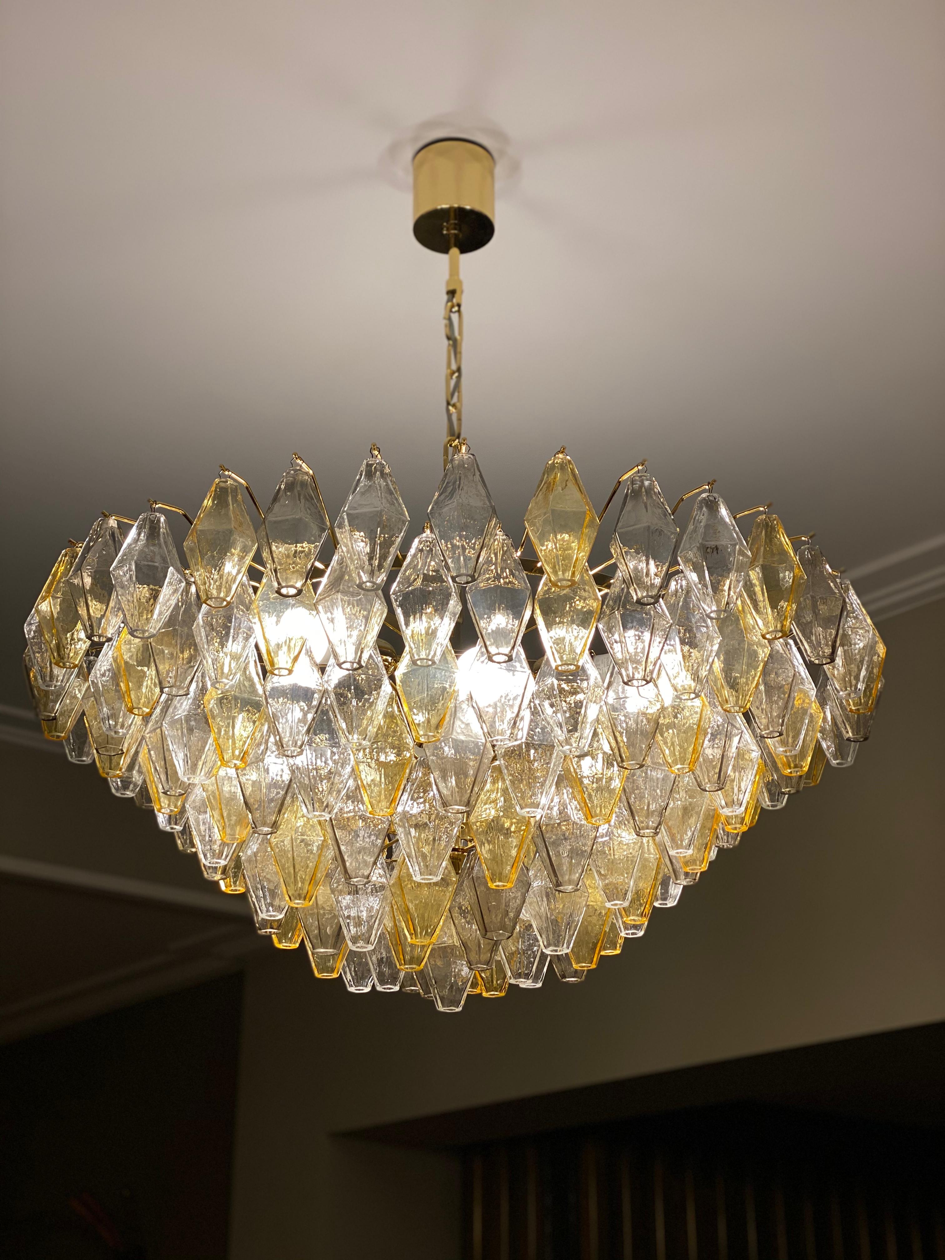 This large custom made chandelier consists hundreds of hand blown gray, amber and clear 