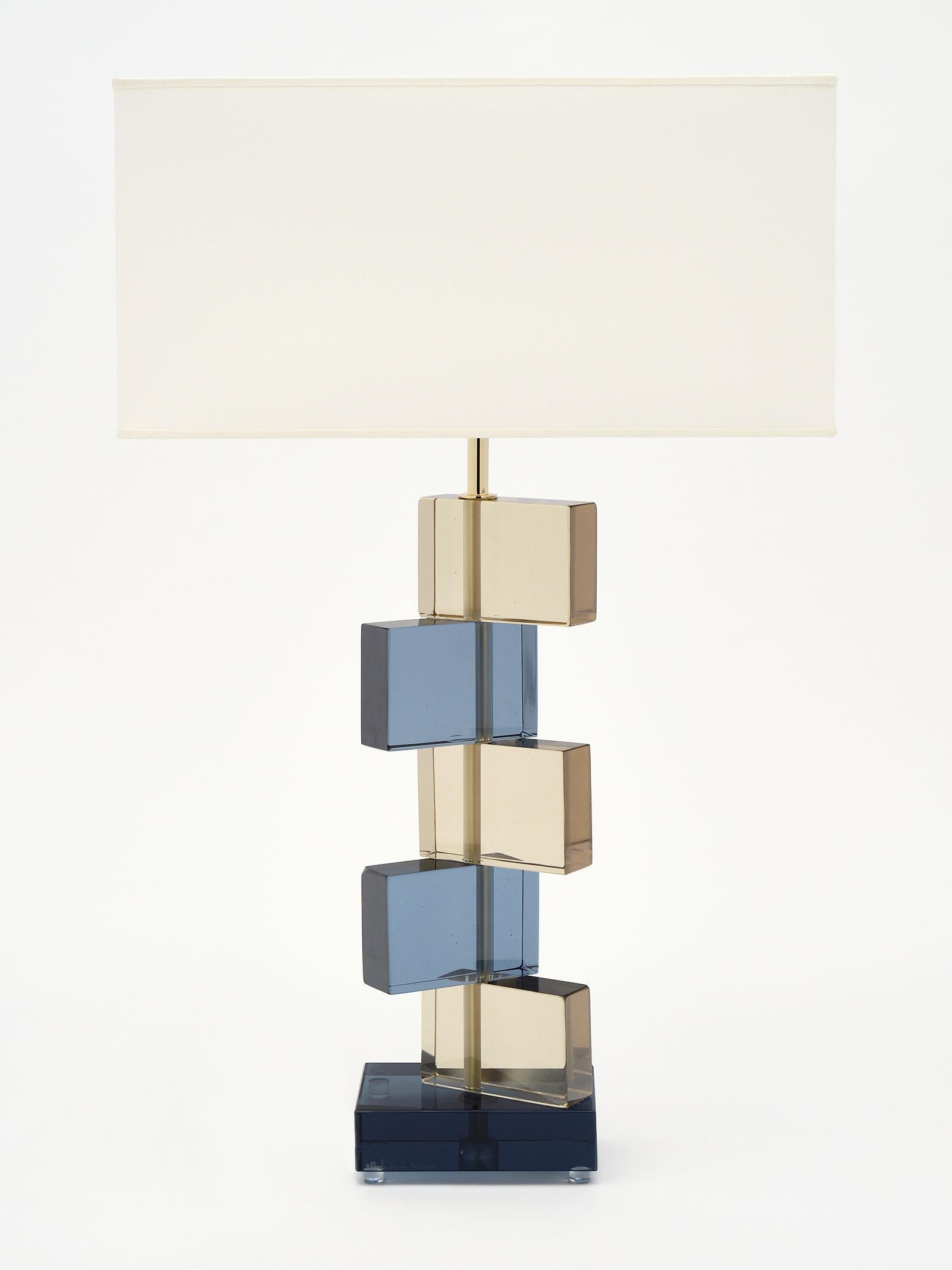 Amber and blue Murano glass geometric lamps signed by maestro Alberto Dona. We love the stacked block effect of the hand blown glass elements. They have been newly wired to fit US standards.

This pair is currently located at our dealer's warehouse