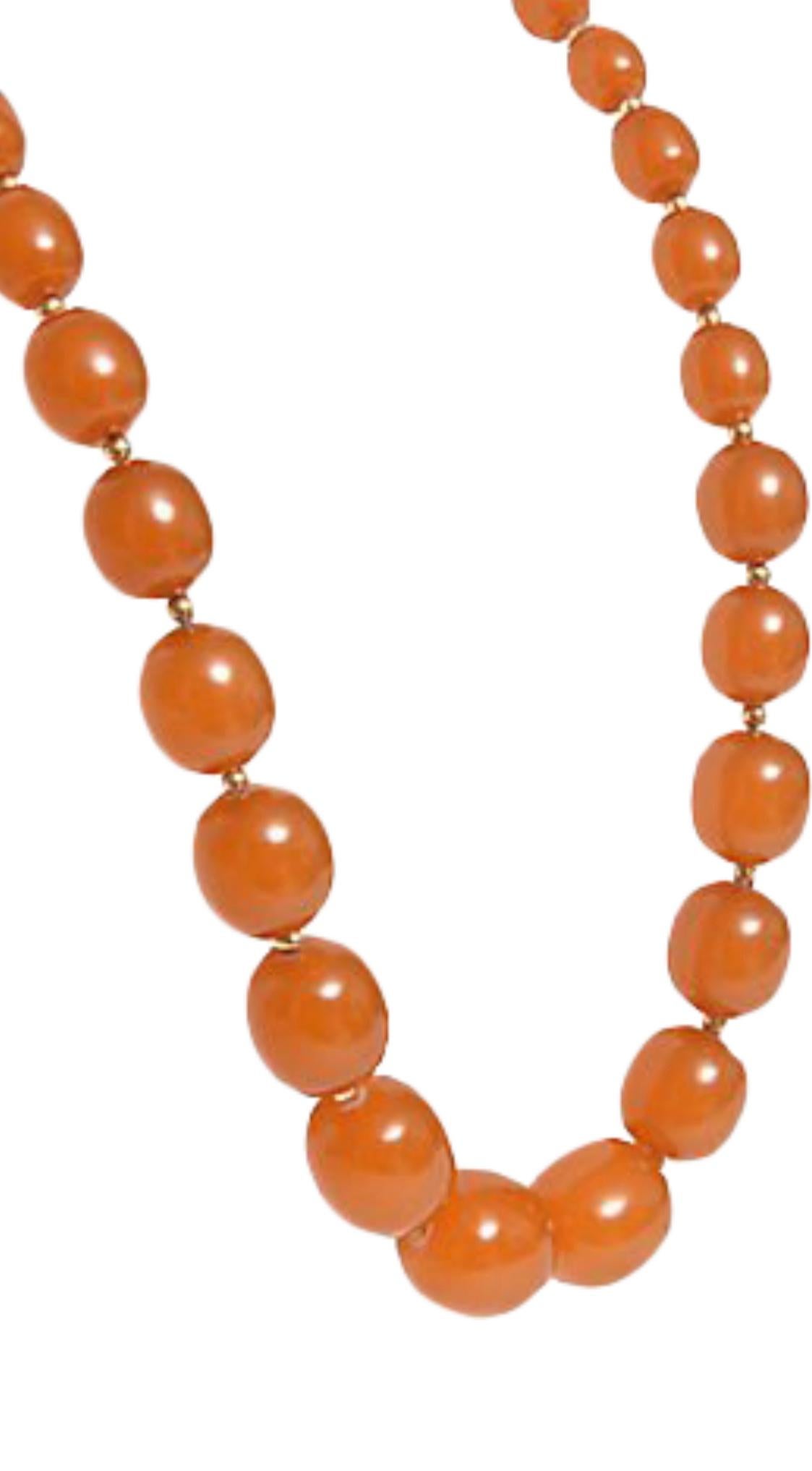 Strand of graduated amber beads interspersed with 14K gold beads. Largest bead is approximately 21mm; smallest bead is 8.90mm. Gold beads: 3.8mm. Claspless.