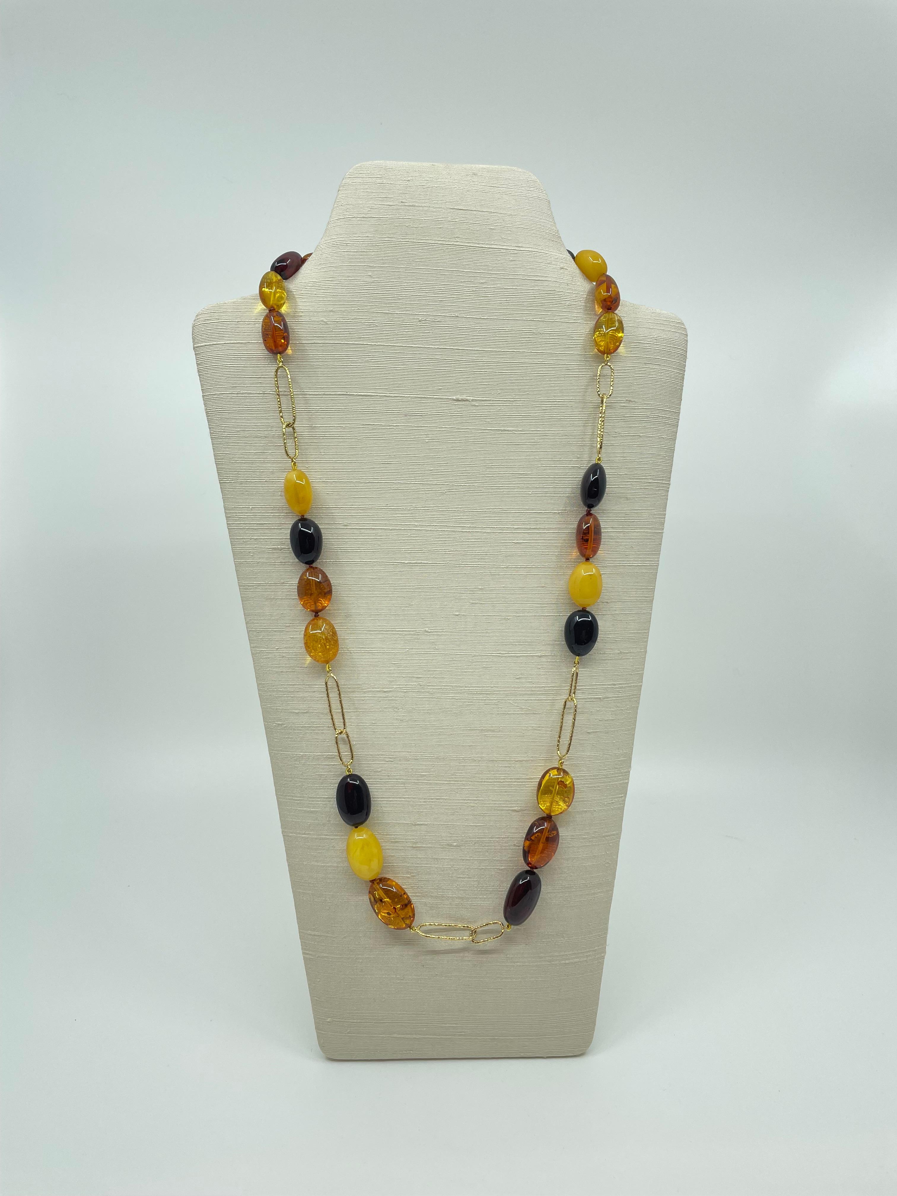 A fabulous 28” L (71.2cmL) necklace with oval Baltic amber beads in butterscotch, lemon, honey and cognac colors, 18k granulated gold links and a granulated 18k gold toggle clasp. 

These beautiful organic gems, with their glorious golden color
