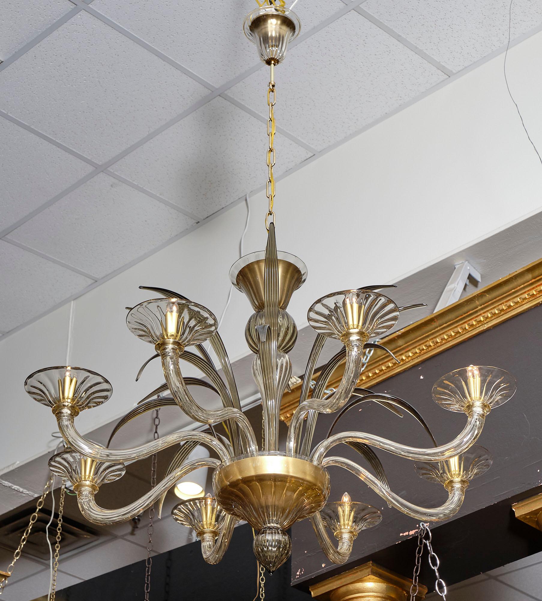 Amber and smoked Murano glass chandelier with eight branches and stylized leaves around the main stem. It has been newly wired to fit US standards.