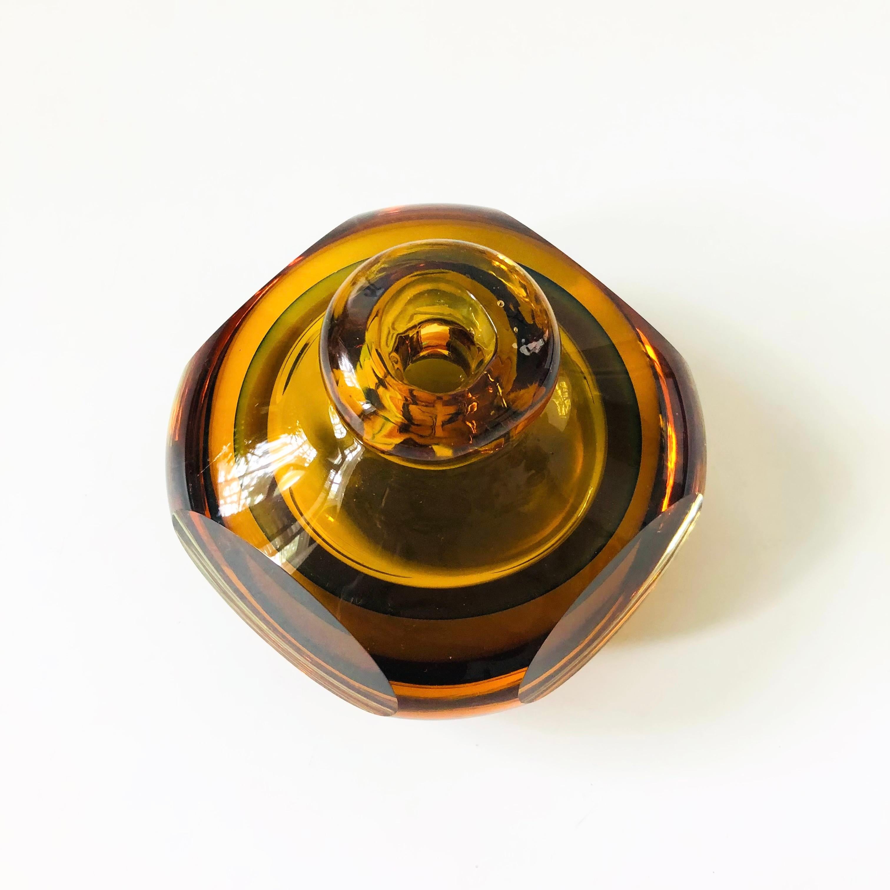 A vintage art glass bud vase. Made of thick heavy glass in a beautiful amber color.

