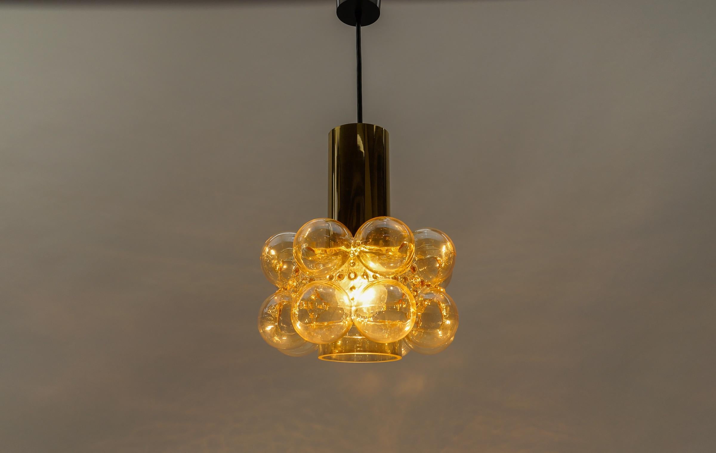 Amber Bubble Glass Ceiling Lamp by Helena Tynell for Limburg, Germany 1960s

Dimensions
Height: 23.62 in. (50 cm)
Diameter: 9.44 in. (25 cm)

The fixture need 1 x E27 standard bulb with 60W max.

Light bulbs are not included. 
It is possible to