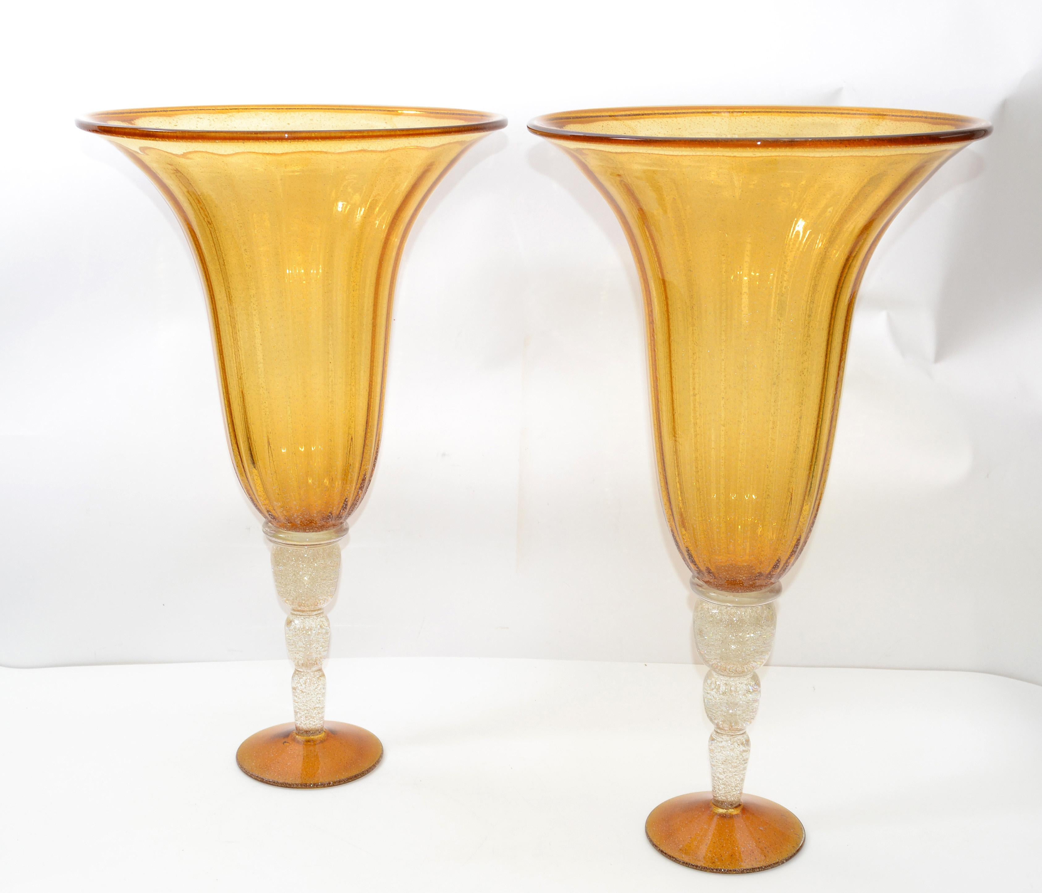 Two tall Venetian Mid-Century Modern Murano amber and clear blown art glass floor flower vase with infused gold flakes and gold dust.
Made in Italy in the late 1970s.
Impressive in form and size.
Measures: Diameter 14.5 & 15.5 inches.
  