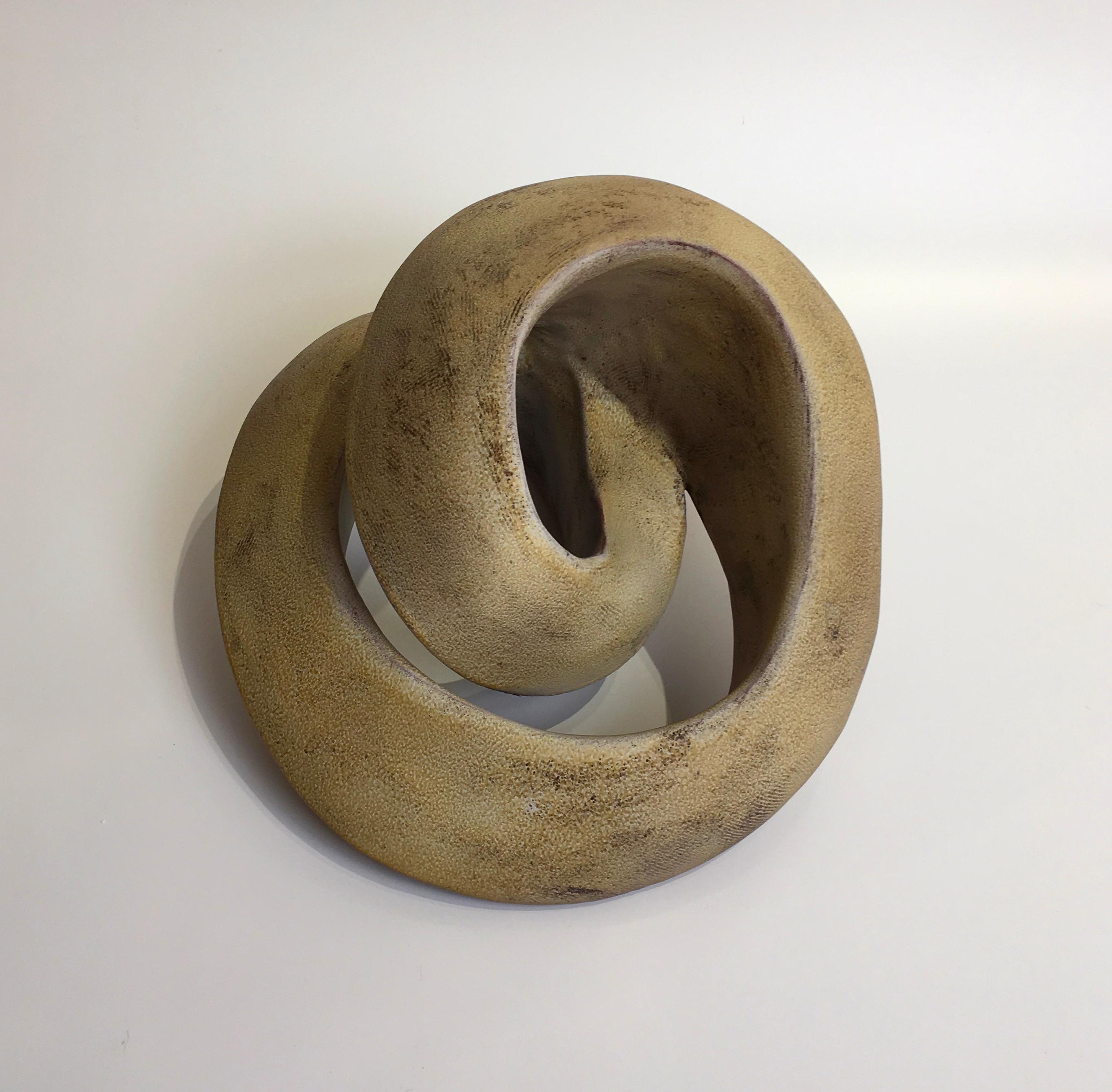 This dynamic coil form object is hand created and fired. The artist achieves the beautiful yellow amber matte surface by sandblasting the sculpture after removing it from the kiln.

Jerilyn Virden
Amber Recoil
Handbuilt earthenware, hollow