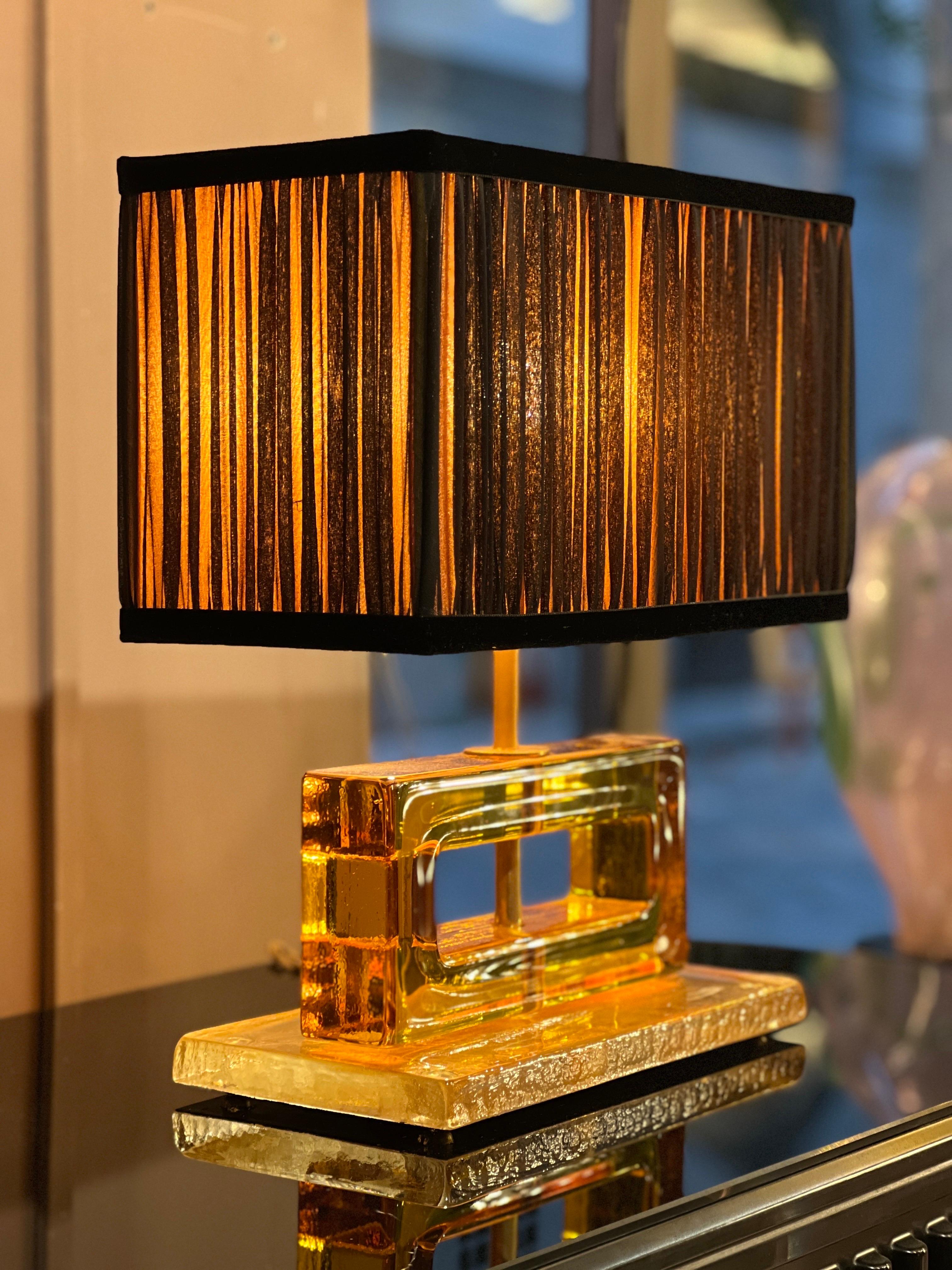 Amber color Murano glass blocks lamps with our hand-sewn yellow and black lampshades.
The geometric glass blocks are solid, thick and heavy, also the base is made of amber color Murano glass. 
The double color lampshades are handmade in our internal