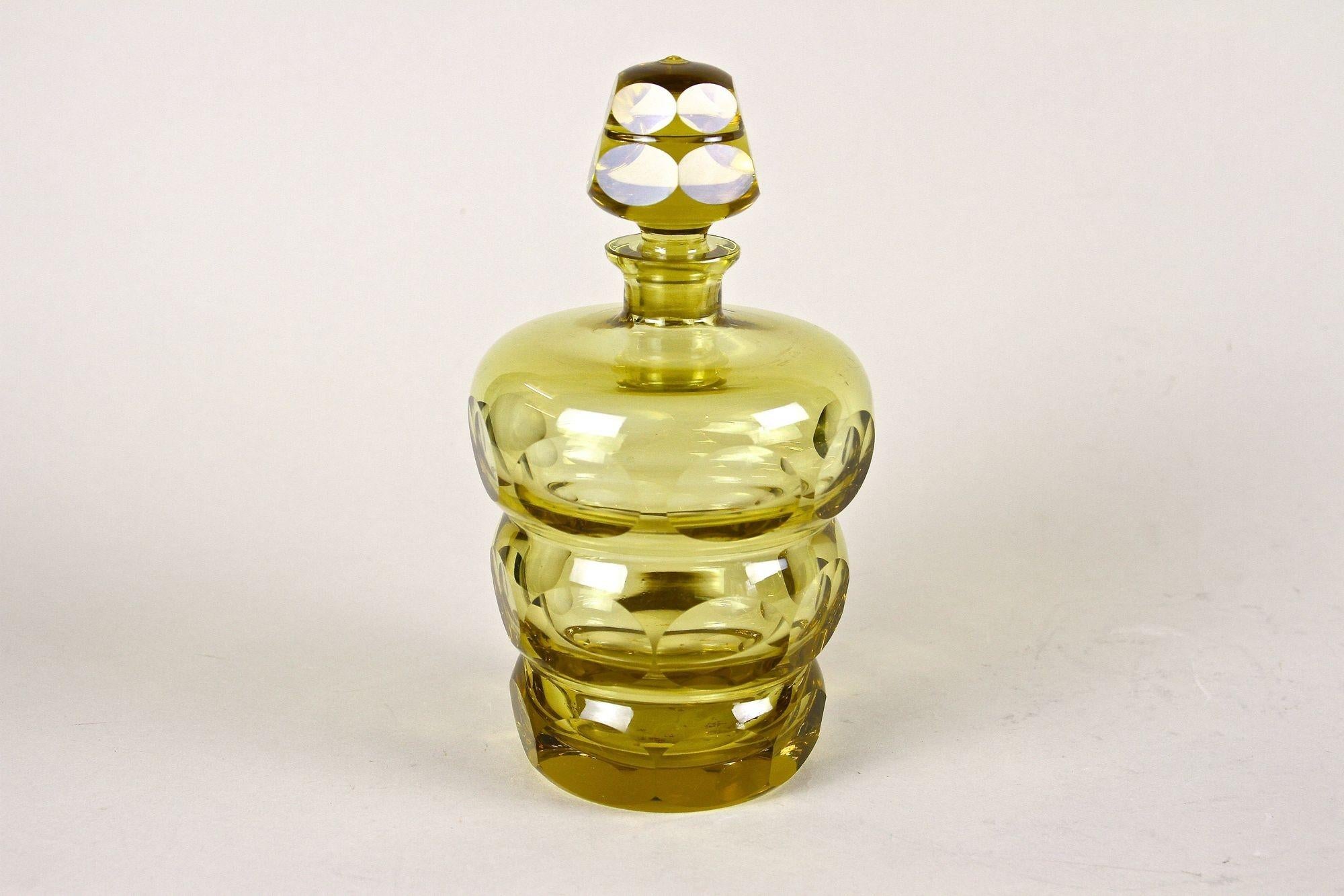 Extraordinary Art Deco cut glass/ liquor bottle from the early 20th century around 1930 in Bohemia. A very appealing designed glass bottle made of very thick unusual amber colored glass. The artfully round shaped body with three 