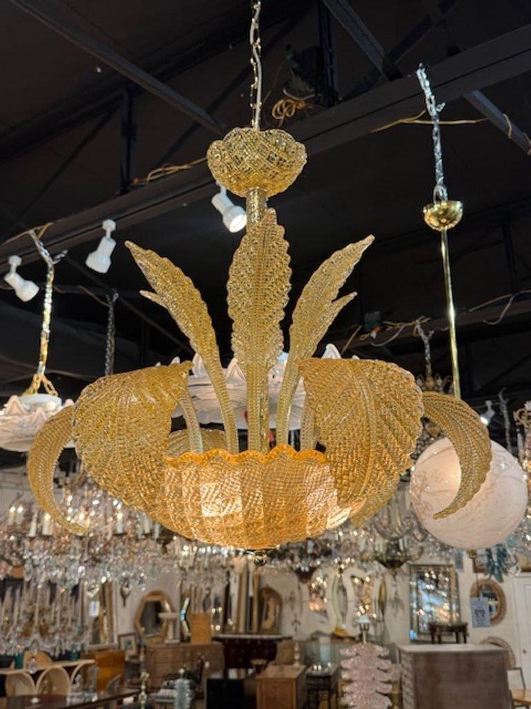 The Amber Colored Murano Glass Leaf Chandelier is a stunning  of lighting fixtures that adds a touch of elegance and sophistication to any room. The unique design featuring intricate Murano glass leaves in a warm amber finish creates a captivating