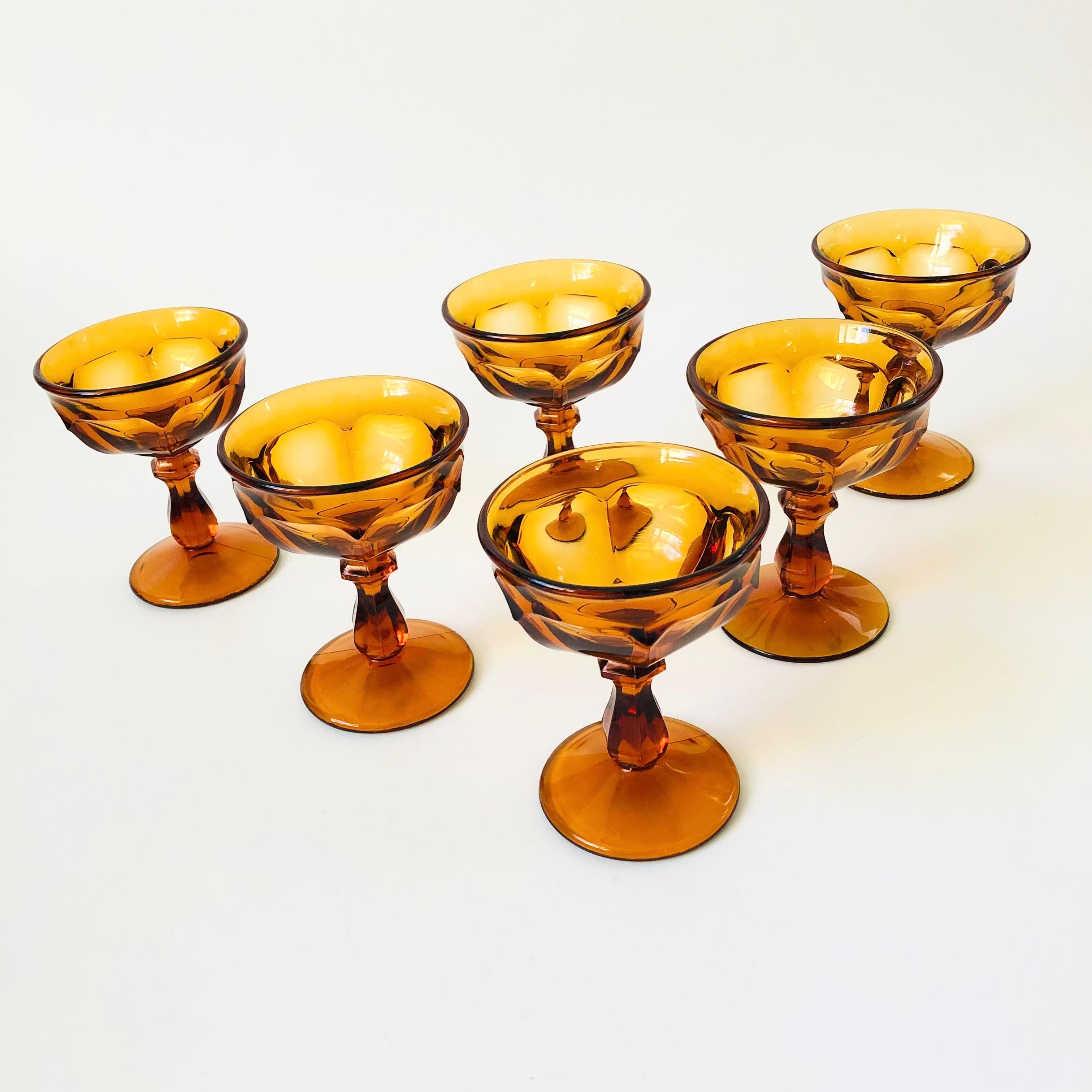 A set of 6 gorgeous amber coupe glasses. Made of thick glass with  lovely ornate design. Perfect for champagne or cocktails.

