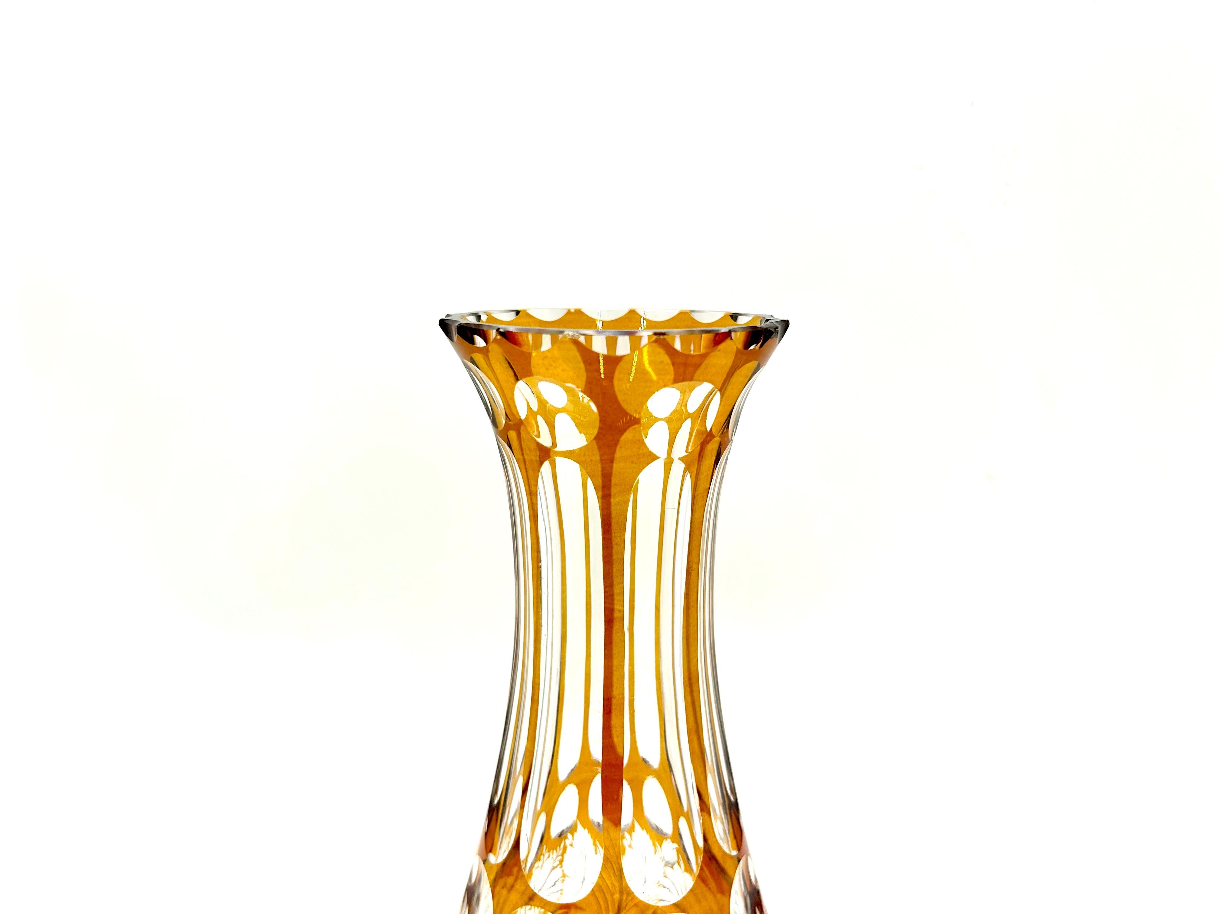 Amber crystal vase cut in a beautiful floral pattern.

Unfortunately, it has a small damage on the edge of the outlet (visible in the 3rd photo)

Made in Poland in the 1960s.

Measures: height: 28cm

outlet diameter: 8.5 cm

diameter: 11cm.