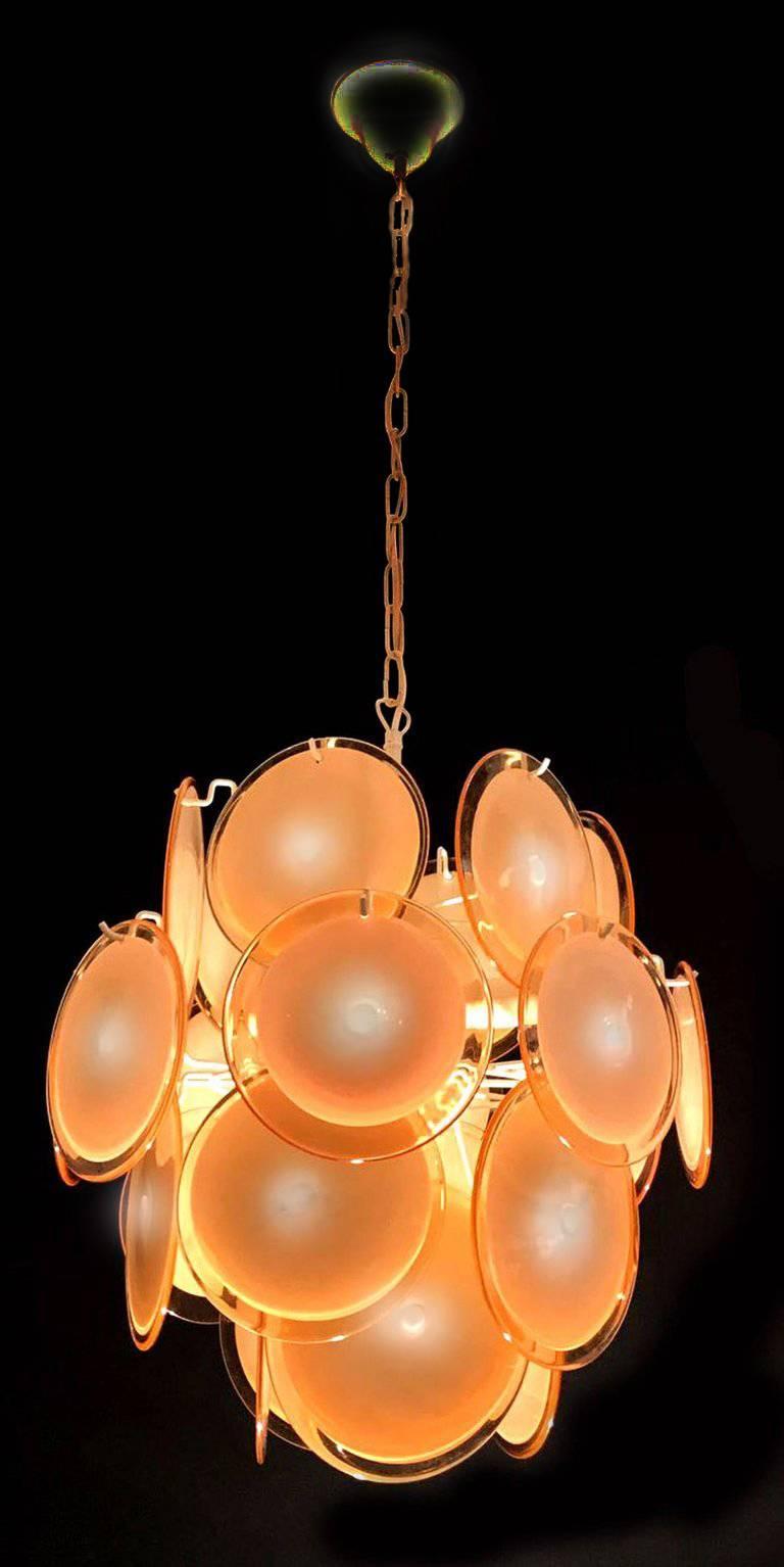 The chandelier is formed by 24 honey discs of precious Murano glass are arranged on floor levels.
 Five E 14 light bulbs Measures: Height without chain 50 cm.
 Price is for 1 item.
