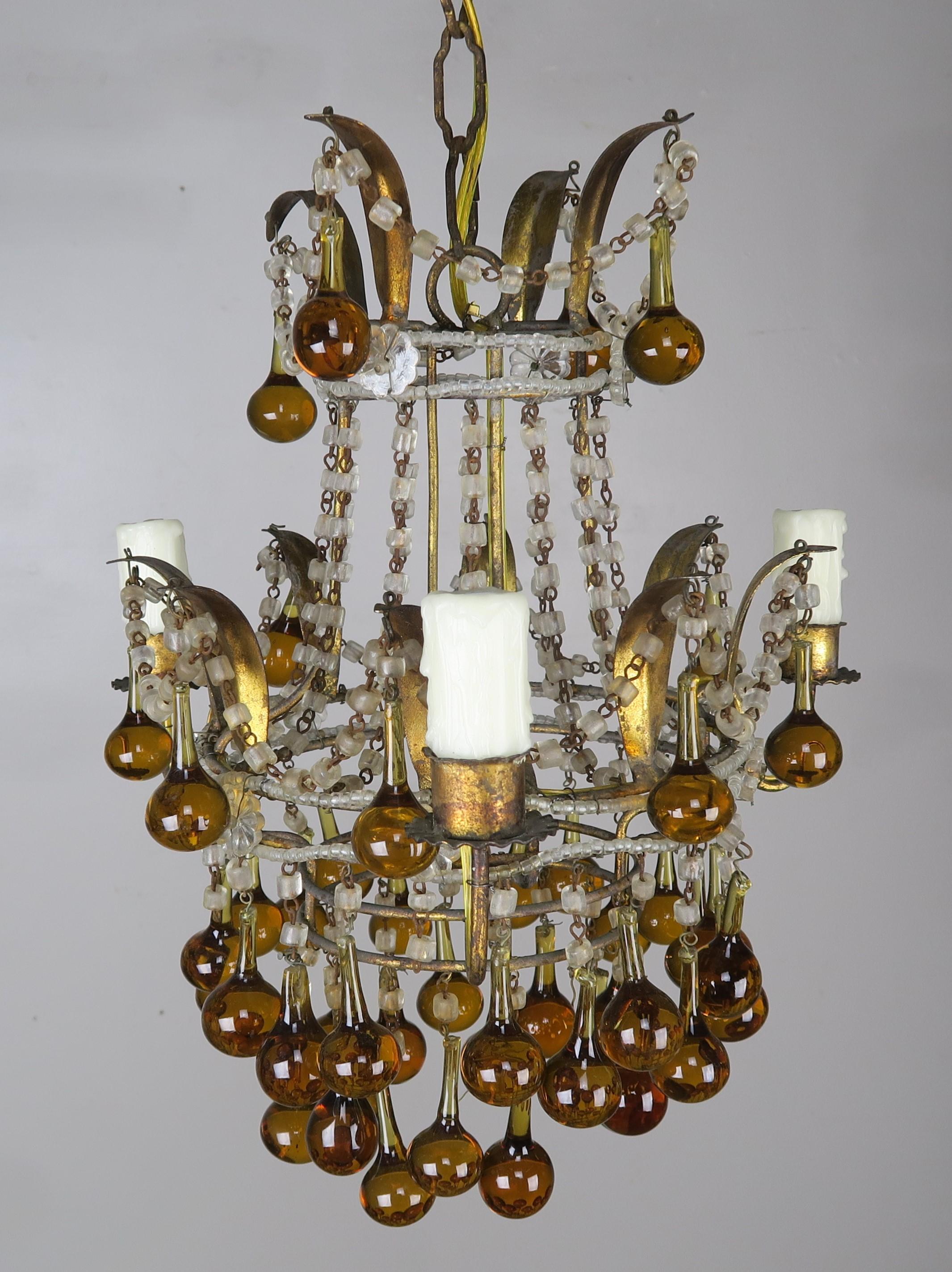 Three light crystal beaded chandelier with amber colored drops throughout. This fixture is newly wired with drip wax candle covers and is ready to install. Includes chain and canopy.
  