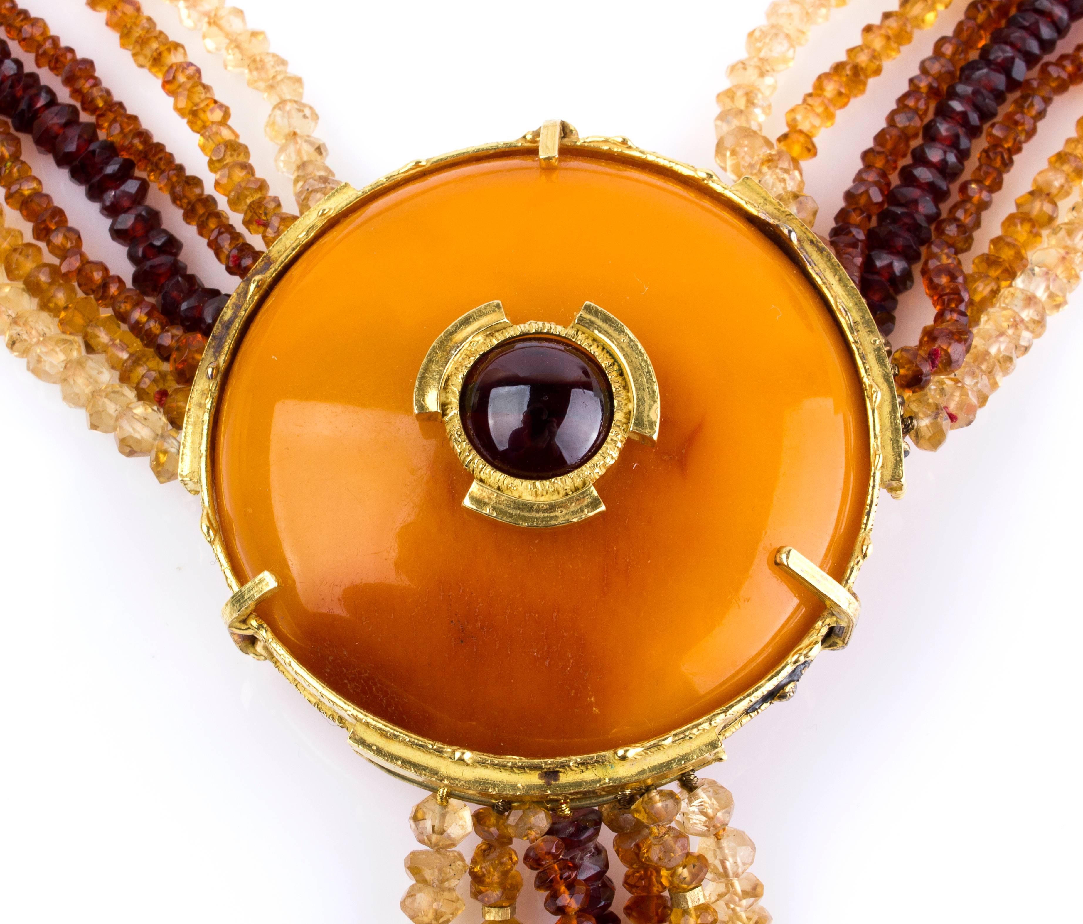 Seven rows of faceted beads of quartz, garnet, baltic amber pendant set cabochon garnet. Pendant diameter 5.5 cm, total lenght 35.5 cm. Weight 196 gr. Item condition grading: **** good. 