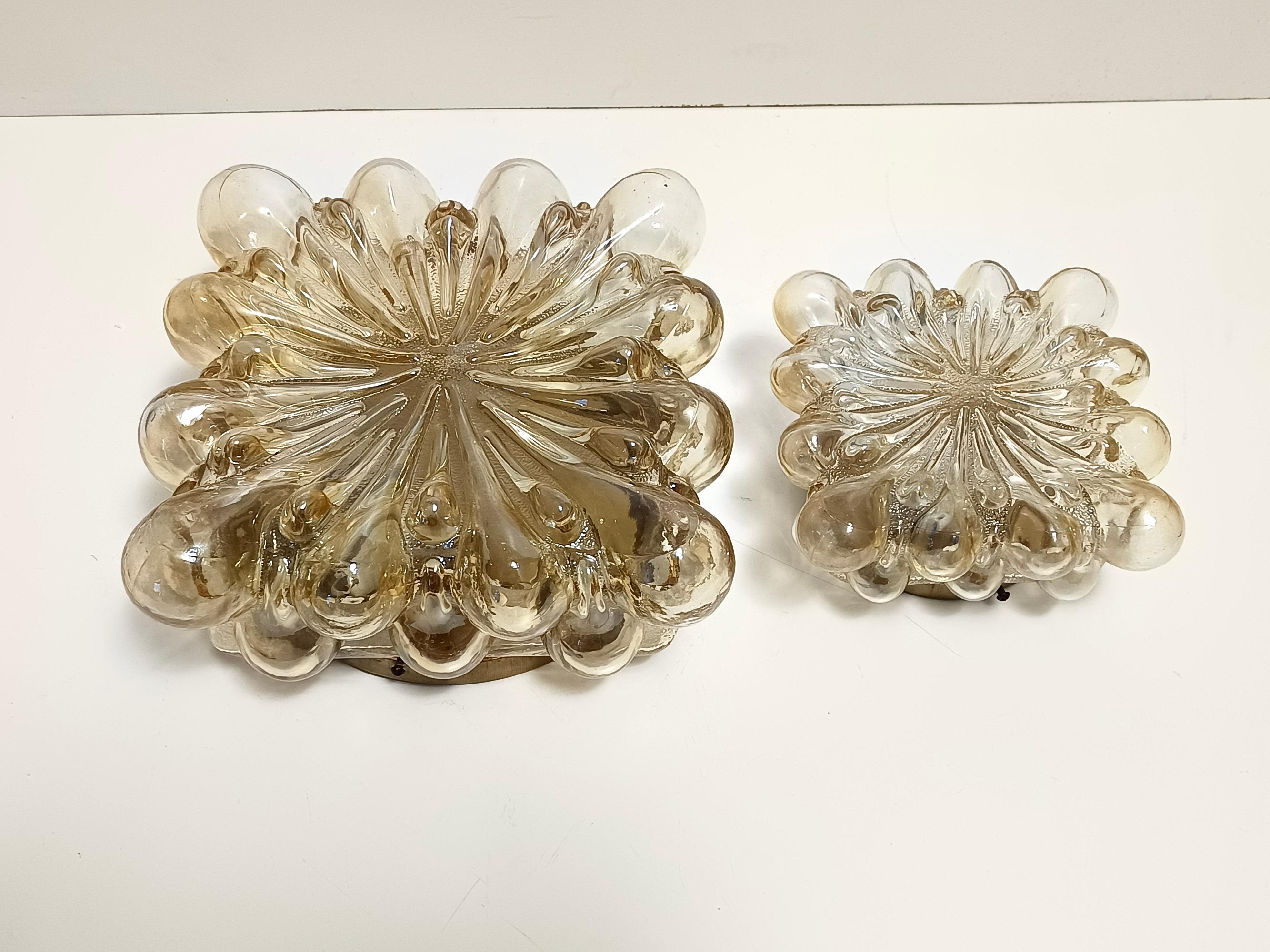 Finland, circa 1970.
This is a postmodern ceiling light in varnished metal and yellow / amber glass by Helena Tynell.
It is a vintage piece, therefore it might show slight traces of use, but it can be considered as in excellent original condition