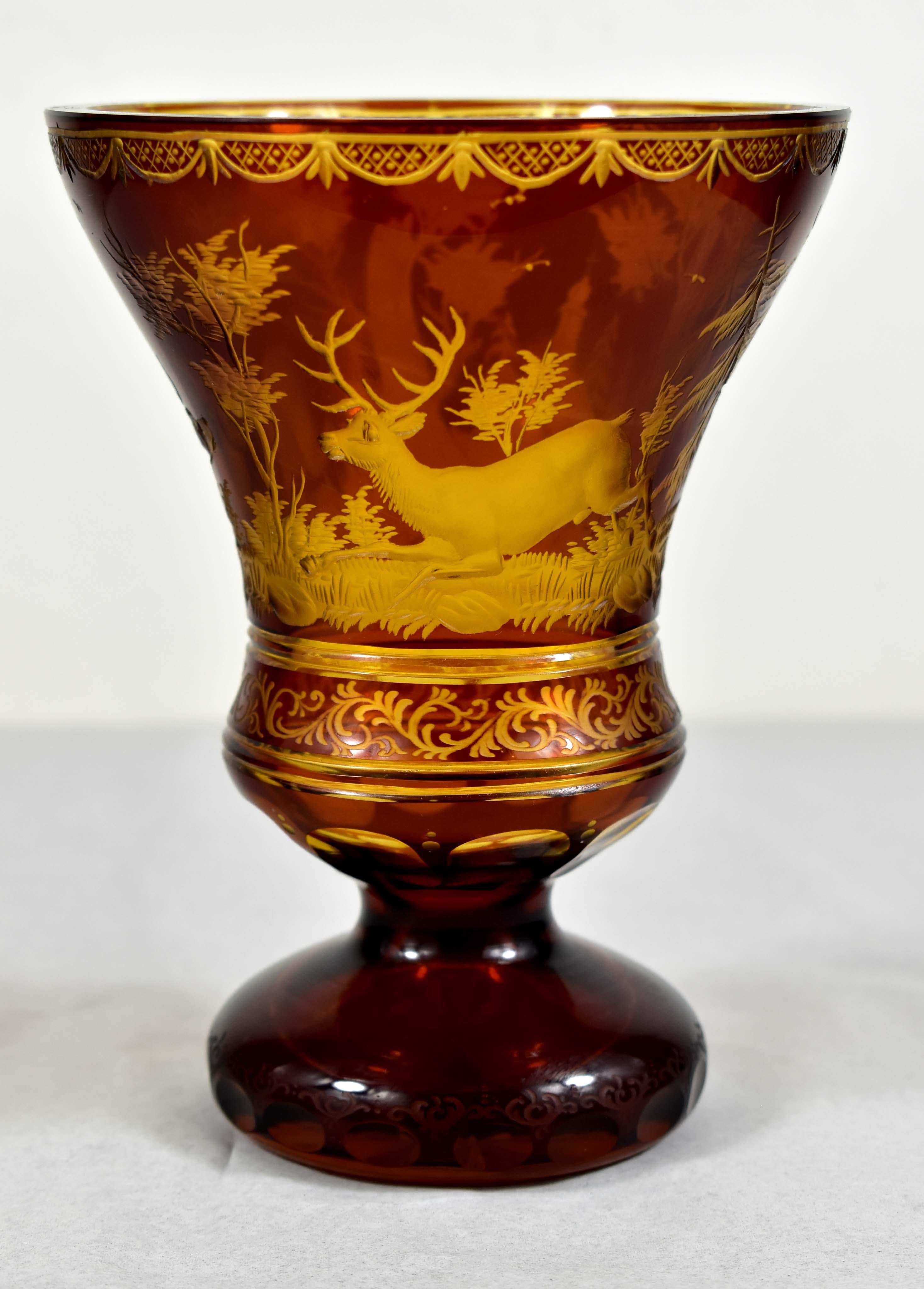 Beautiful cut, engraved amber glass goblet with yellow glaze. The engraving is a deer hunting motif with architecture in the background. All completed with an ornamental engraving. A very typical and popular 19th century motif from which this motif