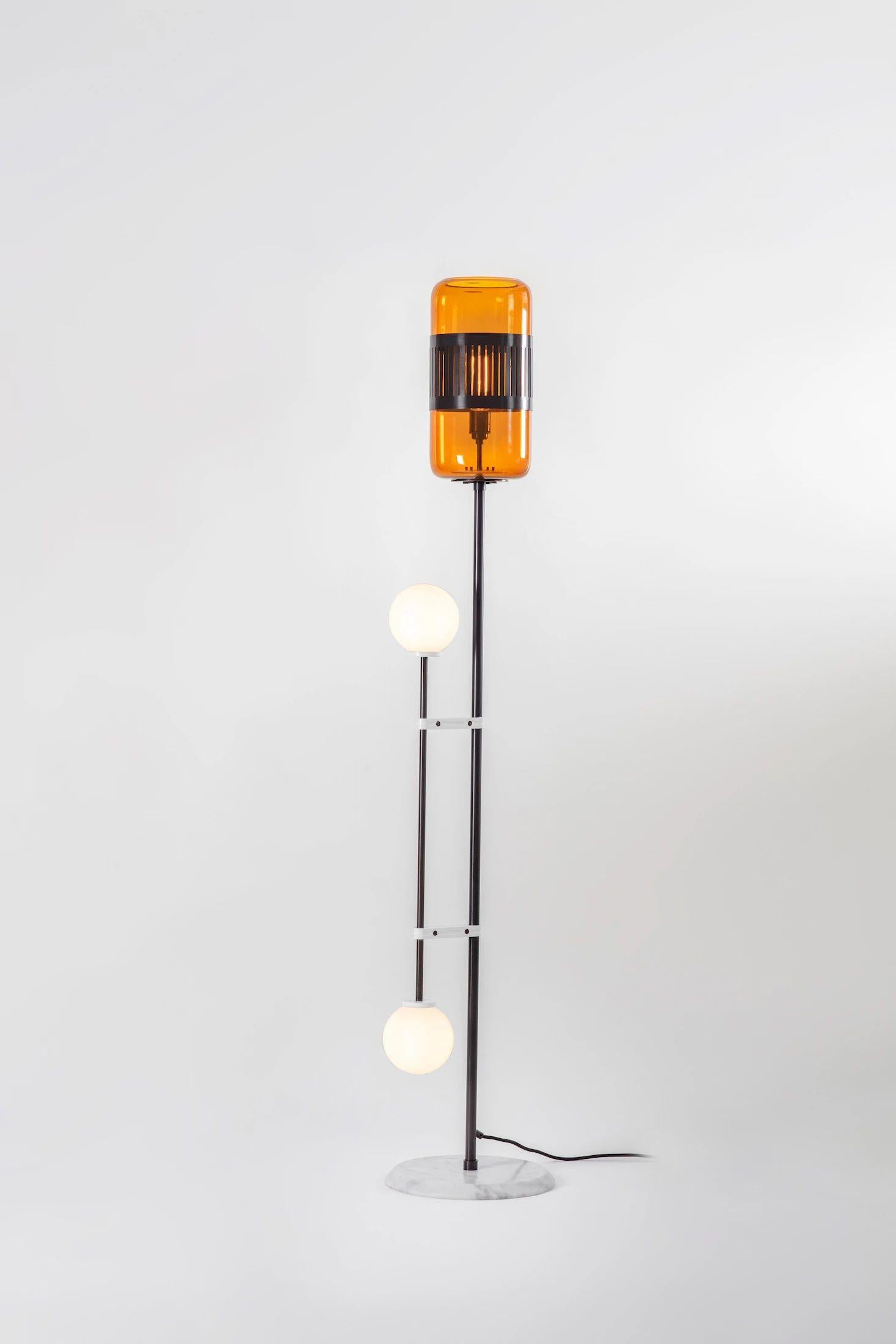 Amber glass Lizak floor lamp by Bert Frank.
Dimensions: 30 x 30 x 159 cm.
Materials: bronze and glass.

Available finishes: brass, opal and blue
All our lamps can be wired according to each country. If sold to the USA it will be wired for the
