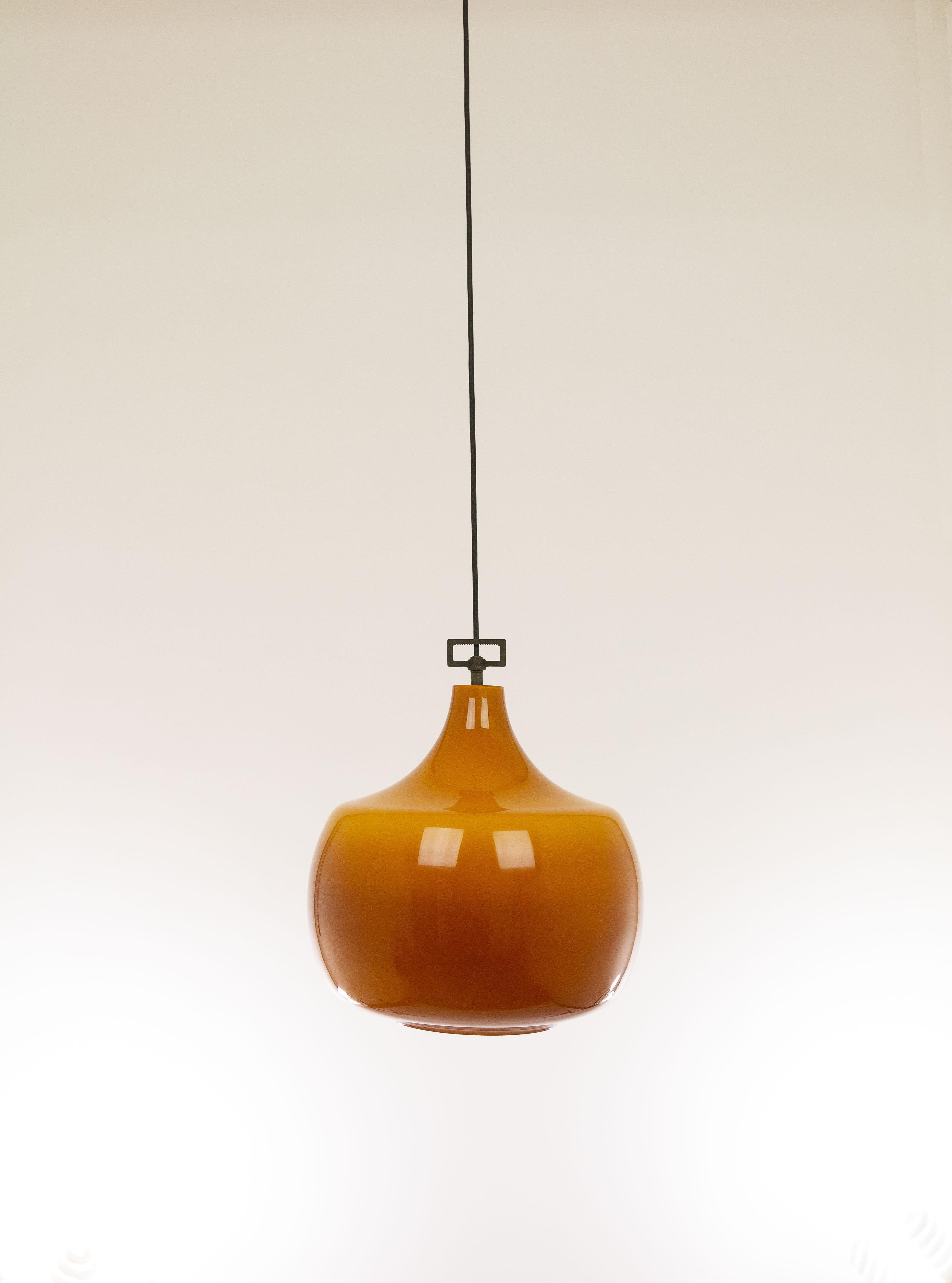 Hand blown amber glass pendant manufactured by Murano glass specialist Venini.

The piece has been rewired with 2 m high-end black fabric cord—for safety and beauty.