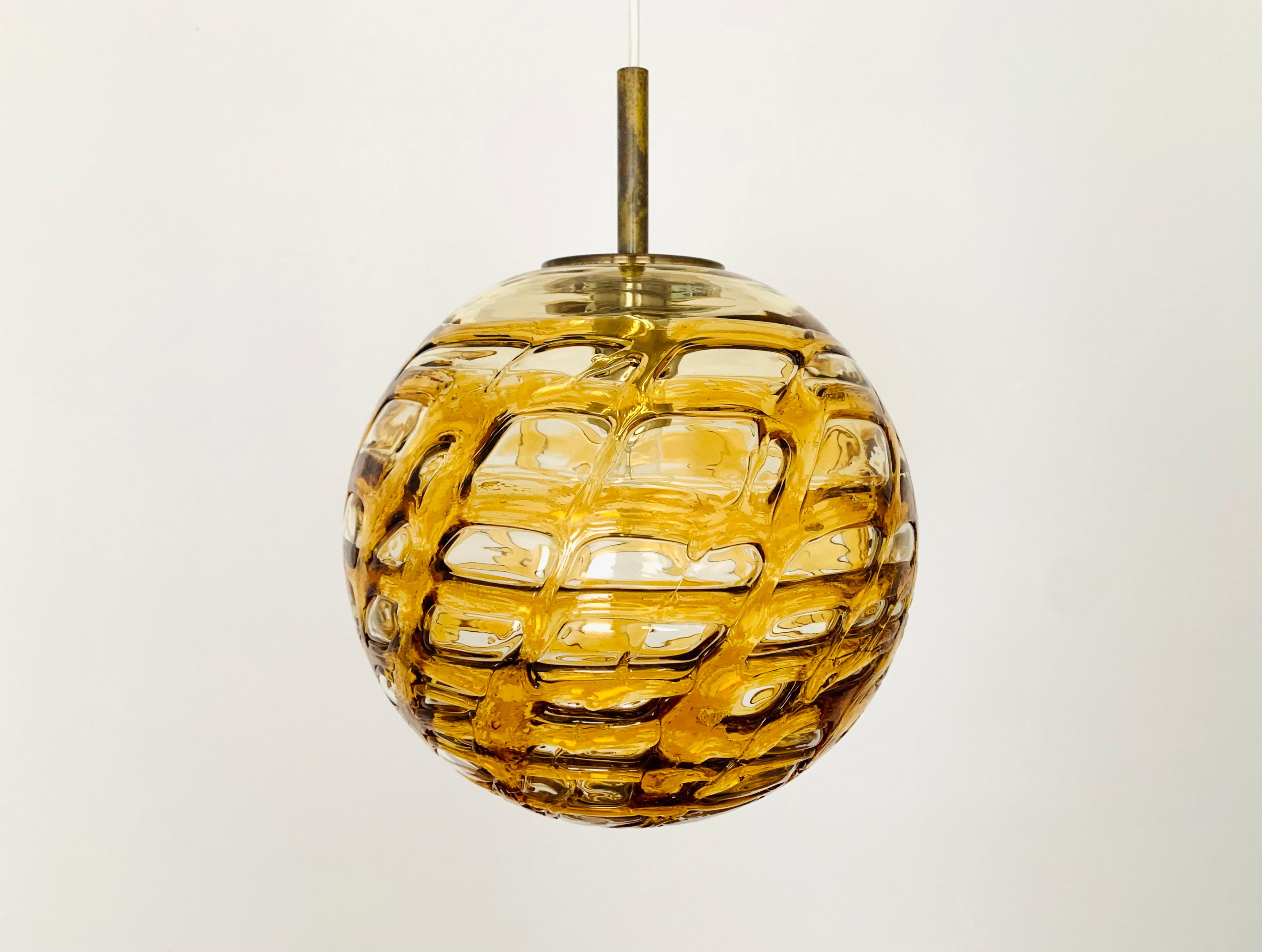 Very nice amber lamp by Doria from the 1960s.
Very elegant Hollywood Regency design with a fantastically glamorous look.
The structure in the glass creates a spectacular light.

Manufacturer: Doria

Condition:

Very good vintage condition