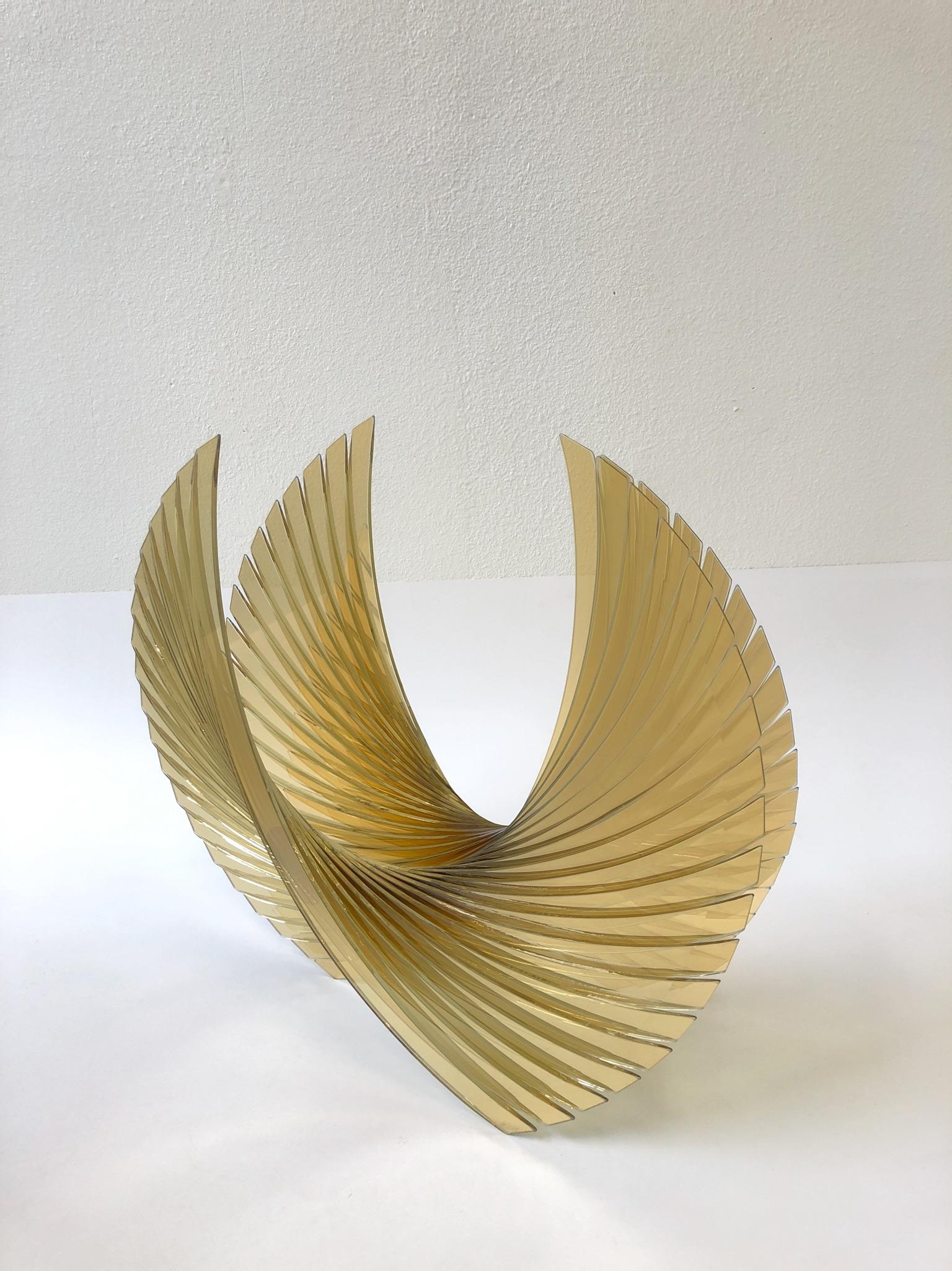 A spectacular amber hand cut-glass sculpture “Gold Amber Wings” by Tom Marosz.
The sculptor hand-cuts and bevelled the edges. The sculpture is signed and dated 2005.
Dimensions: 22” high 9” deep 24” wide.