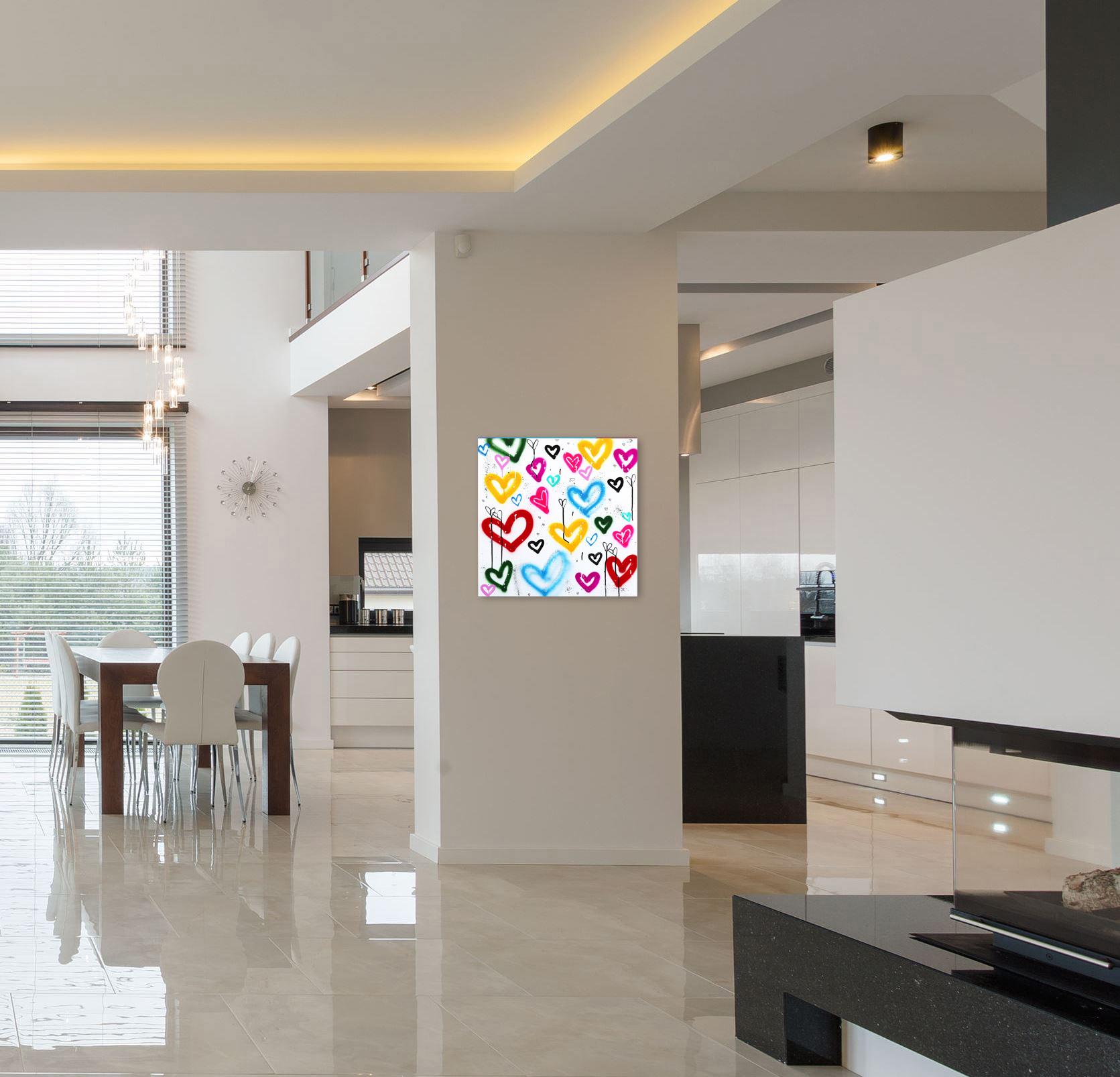 Amber Goldhammer’s “Heart Heaven”, a joyful 30-inch square graffiti-inspired painting, radiates love, positivity, and vibrant energy through its playful composition of colorful hearts. Known for her ability to combine urban street art aesthetics