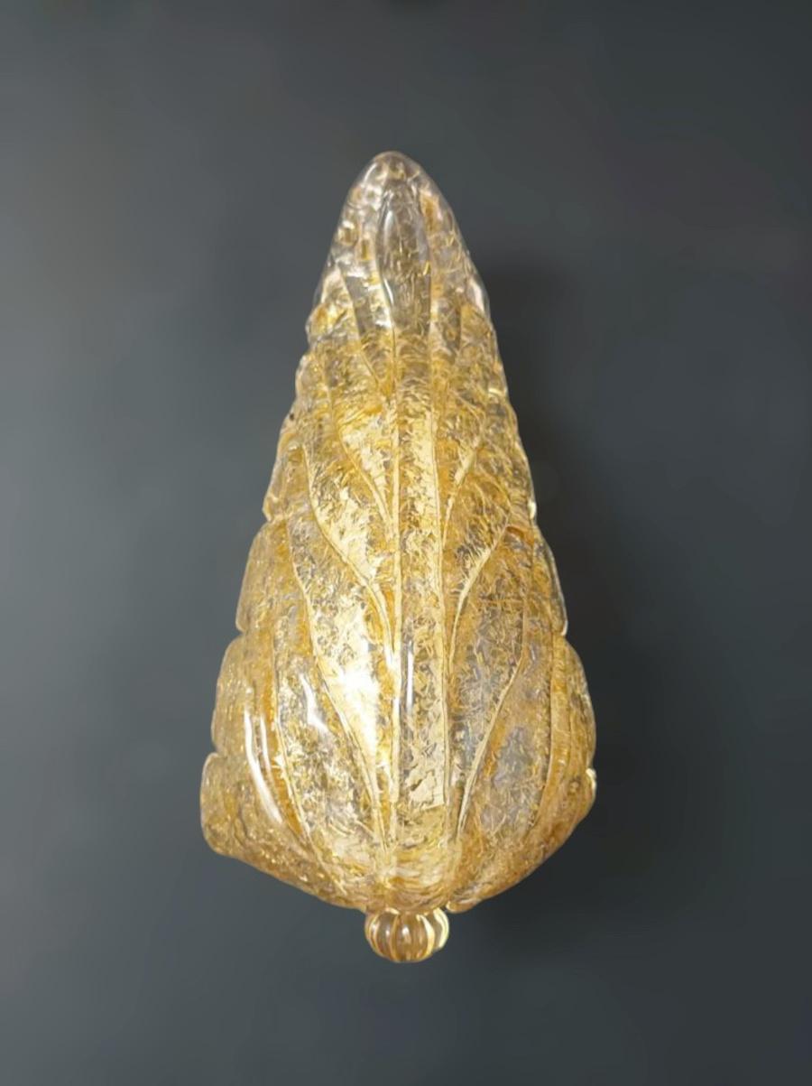 Italian wall light with a clear Murano glass leaf hand blown with amber Graniglia to produce granular textured effect, mounted on metal frame / Made in Italy in the style of Barovier e Toso
Measures: Height 12 inches, width 6 inches, depth 4